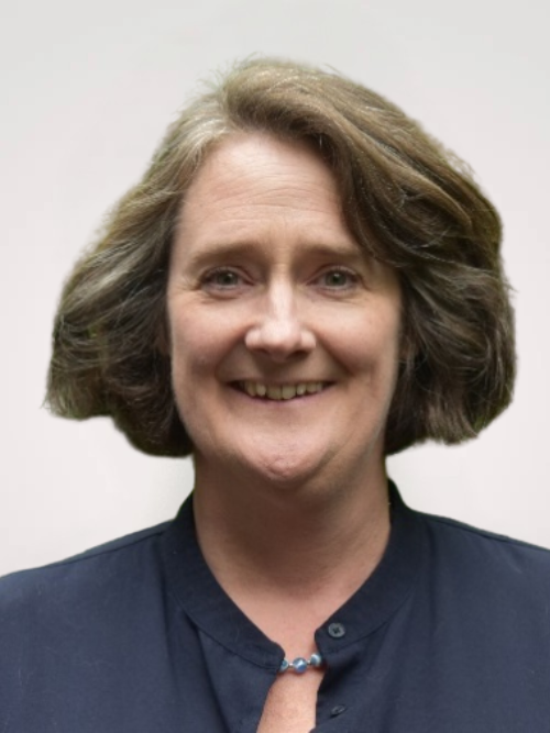 Portrait of a smiling man woman with short brown hair, wearing a navy shirt.