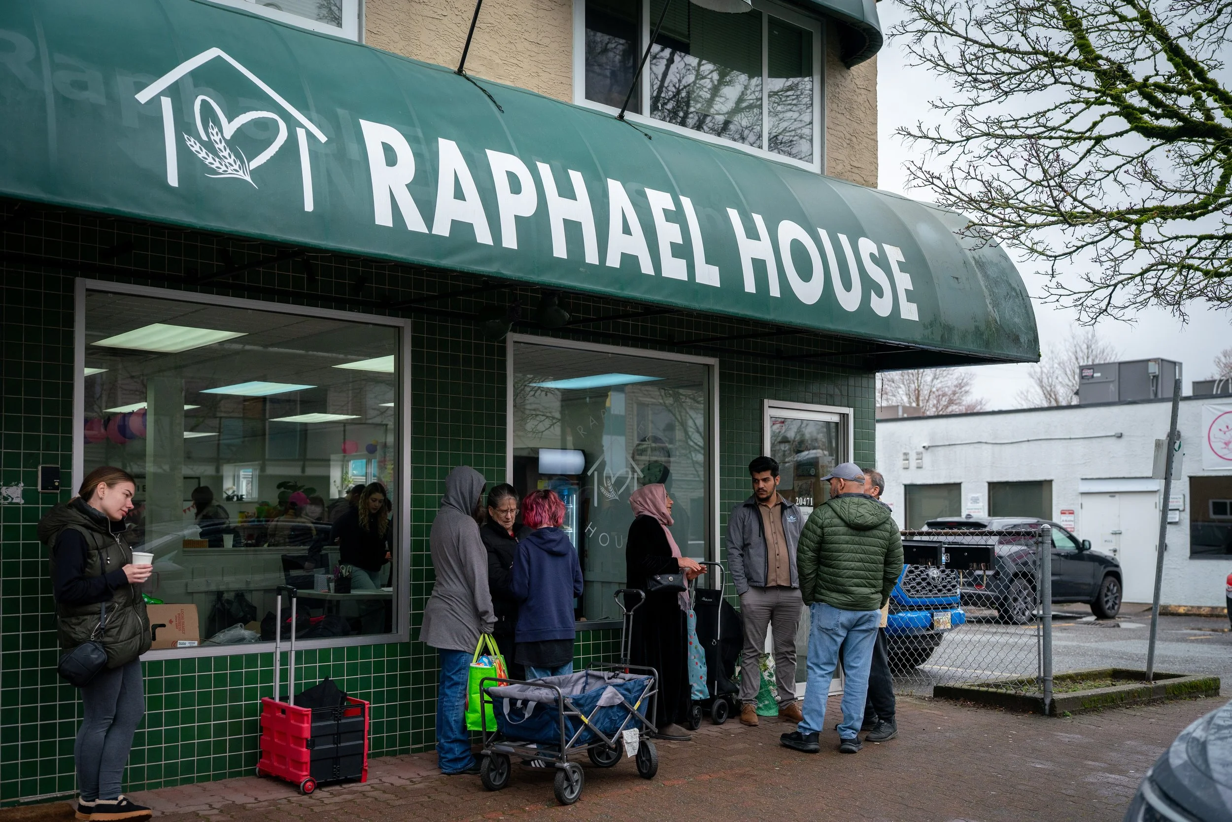 Families and volunteers gathered at Raphael House community food hub in Langley BC