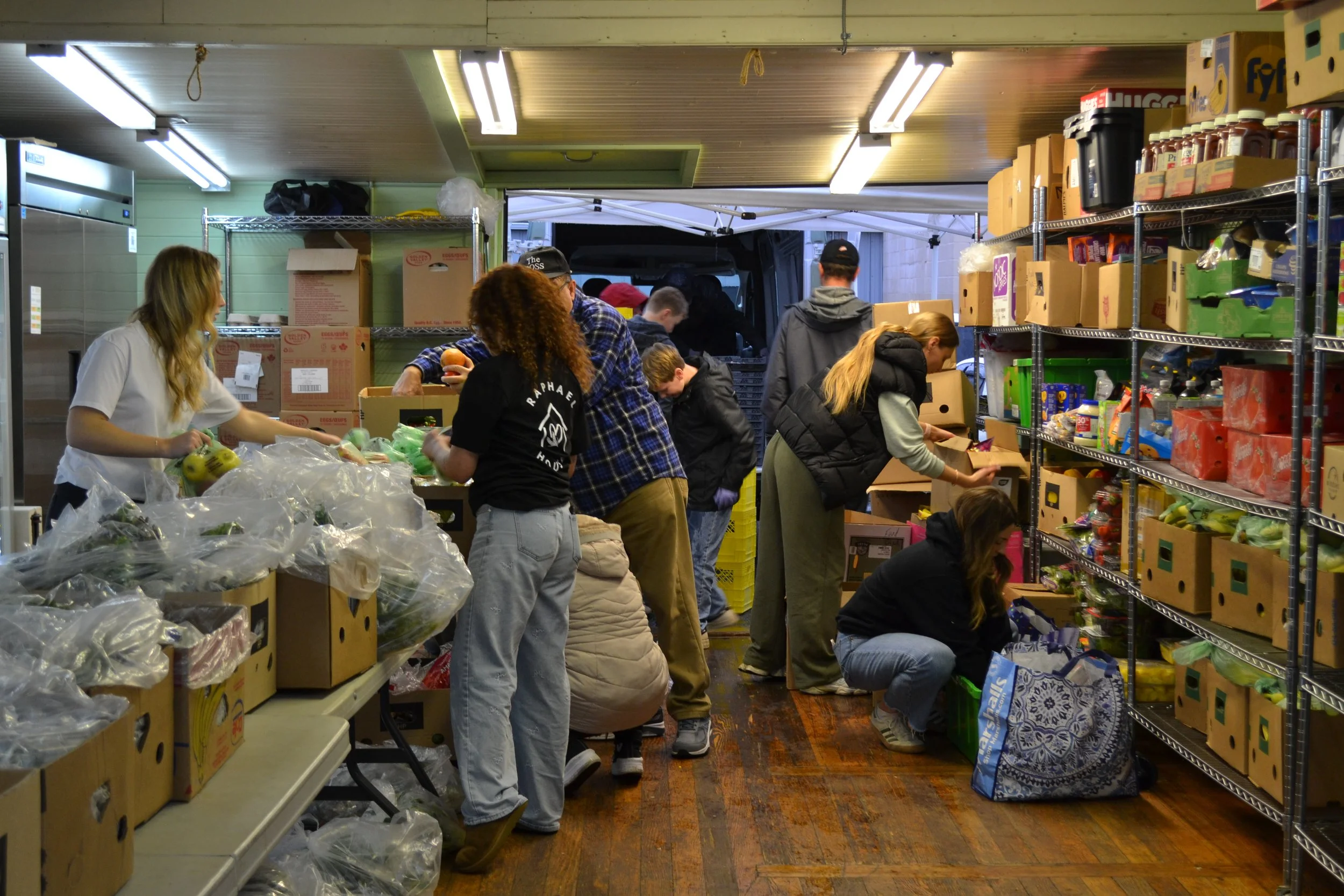 Raphael House volunteers serving families at the Langley food hub