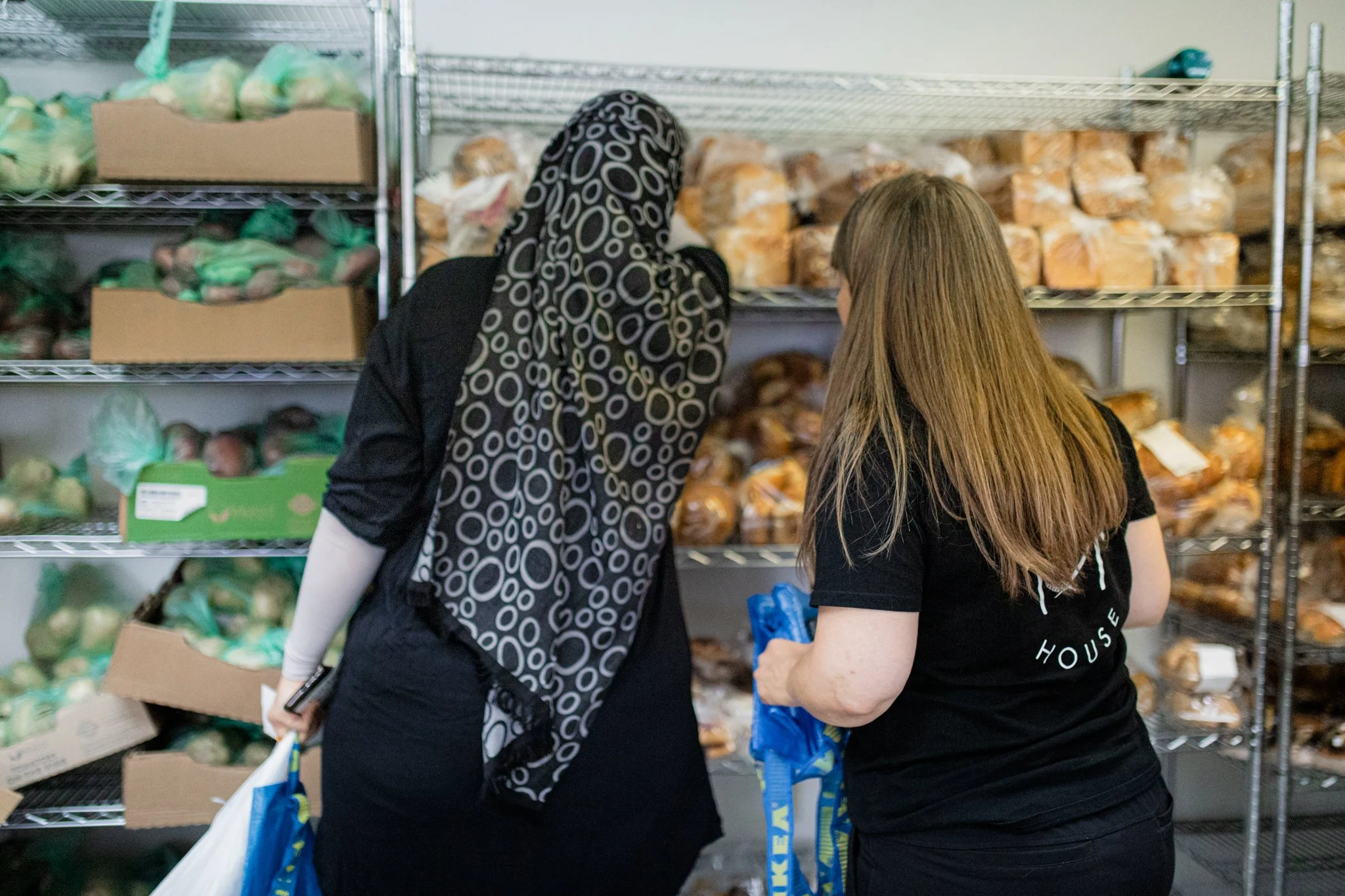 Shelves of donated food supplies organized at Raphael House in Langley BC
