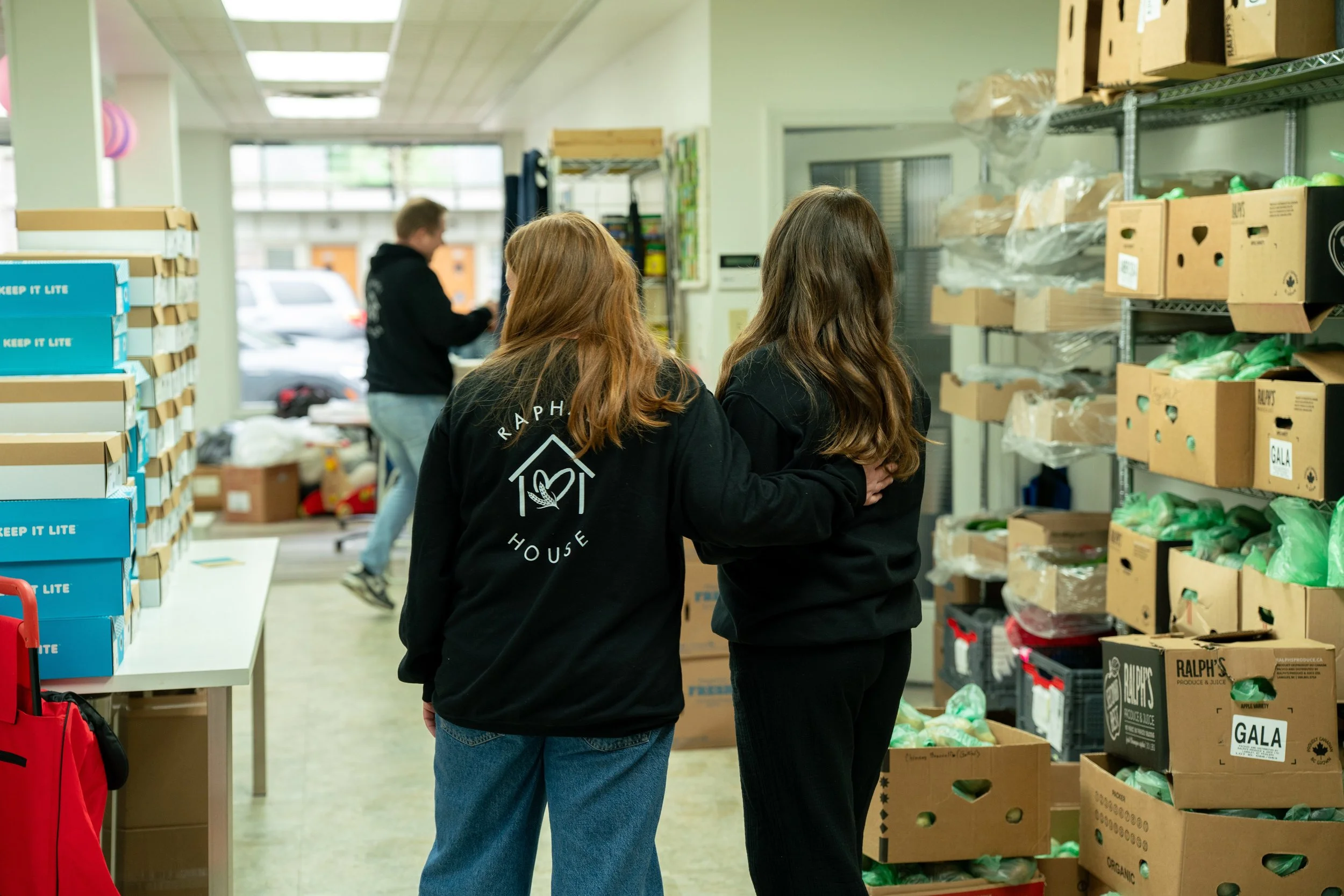 Raphael House volunteers working together during food distribution in Langley