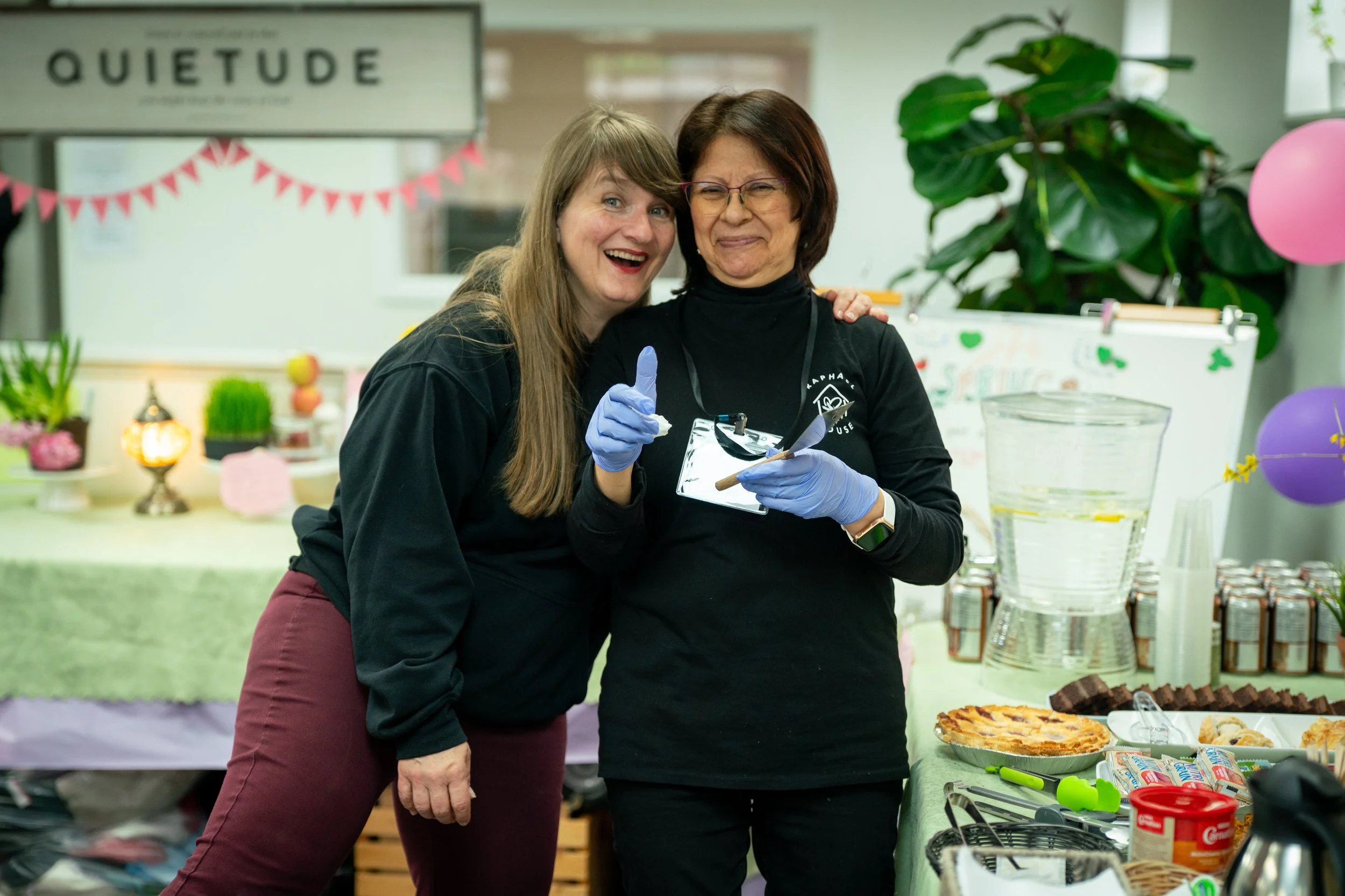 Raphael House volunteer greeting a family at the Langley community food hub