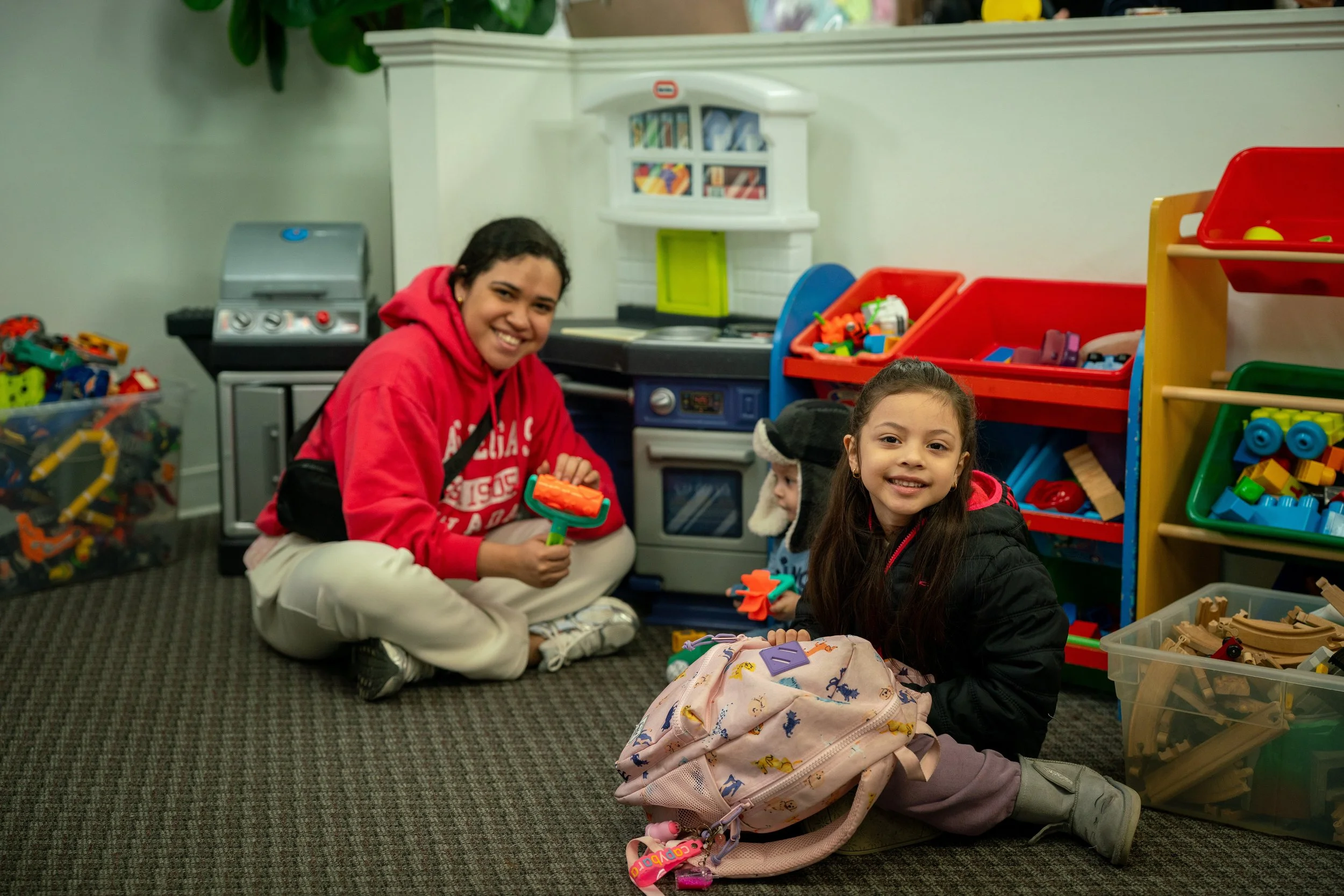 Raphael House volunteers and families during a weekly food hub session in Langley