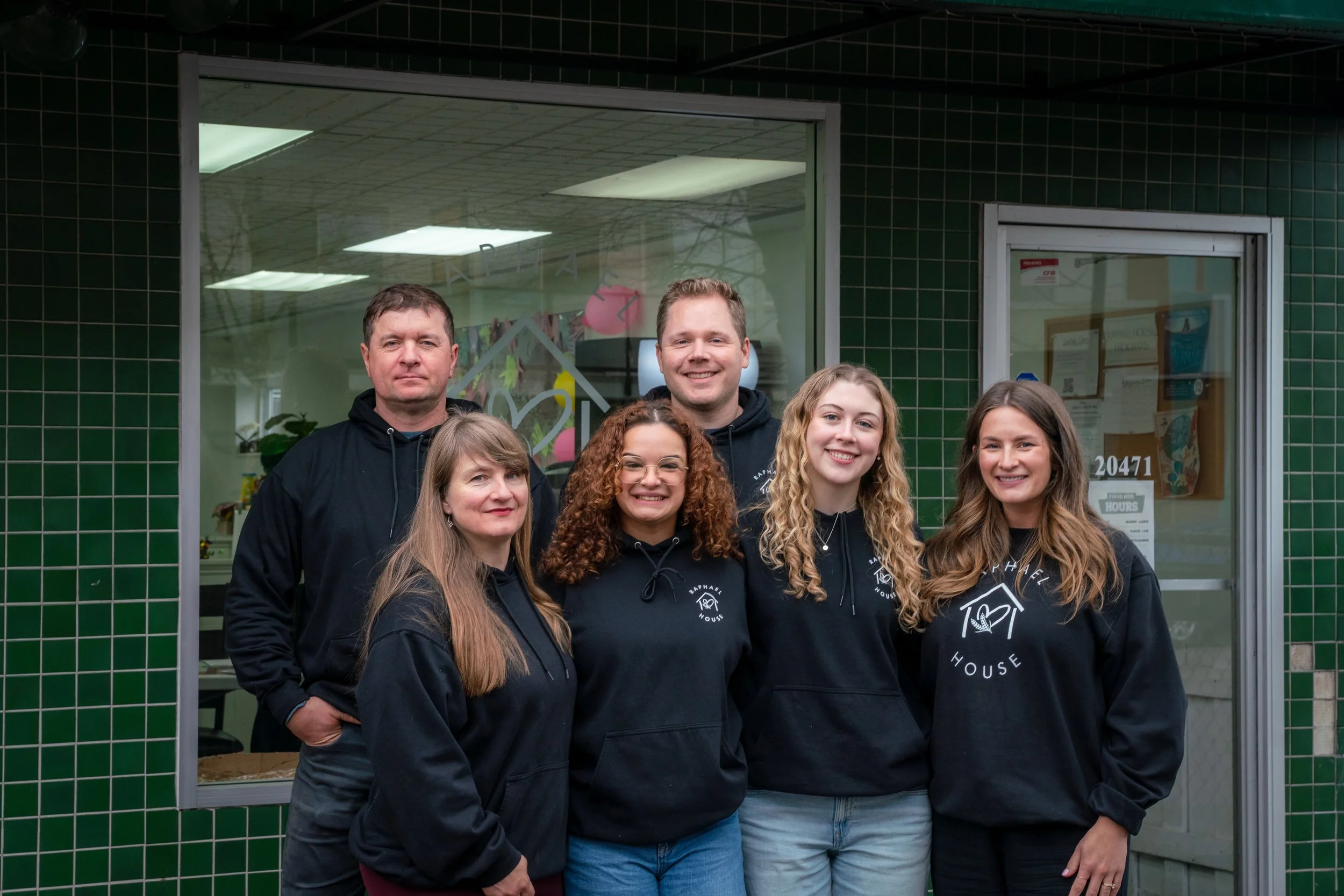 Raphael House staff managing food storage and operations at Langley facility