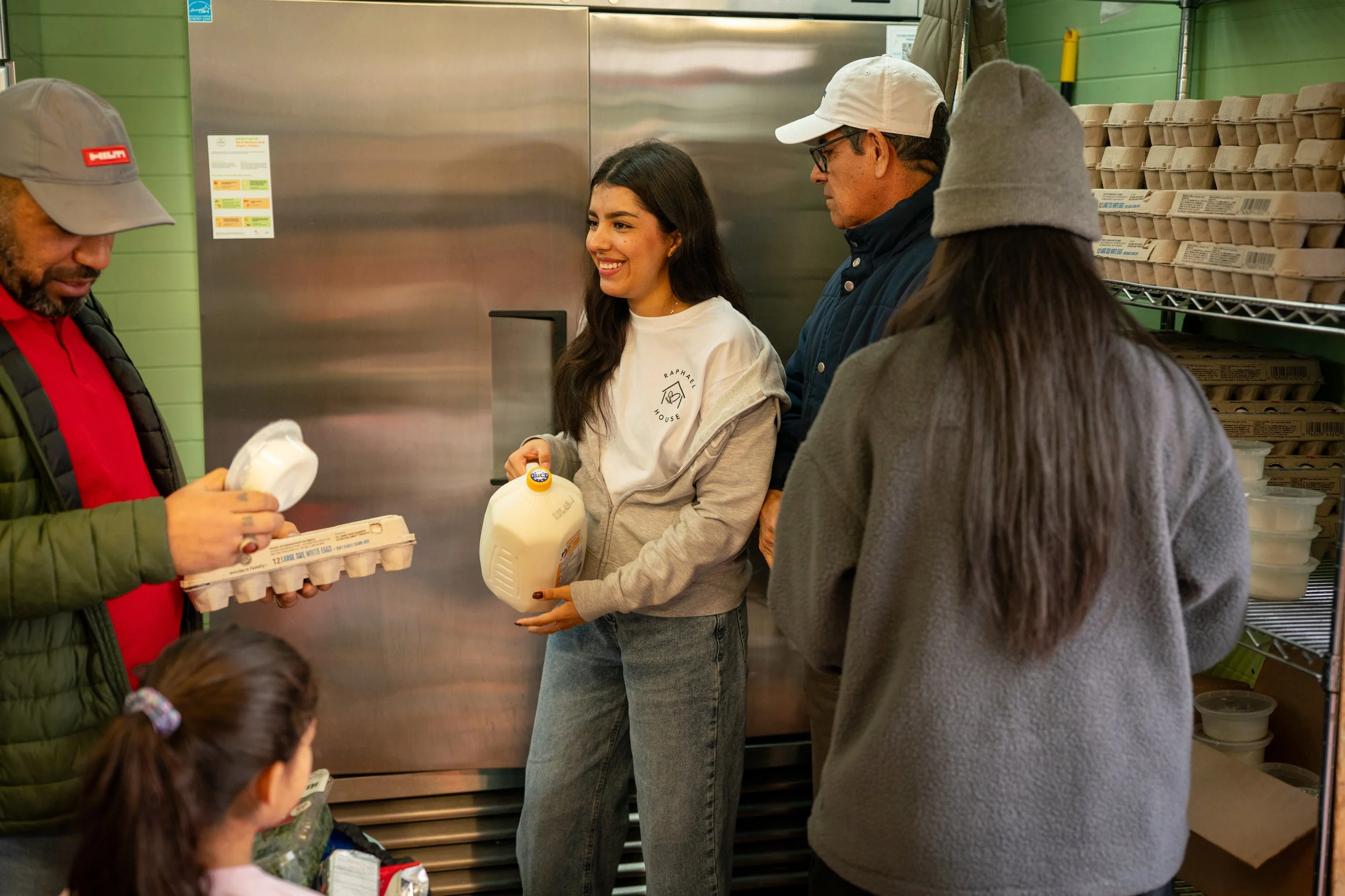 Families and volunteers at Raphael House weekly food pickup in Langley