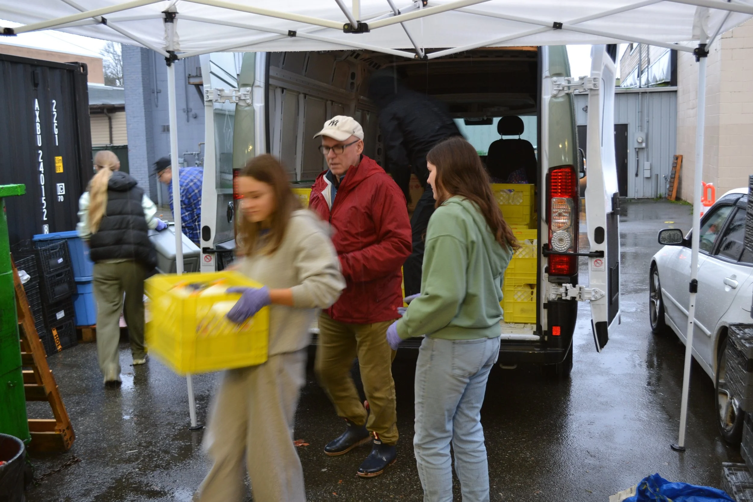 Raphael House volunteers serving families at the Langley food hub