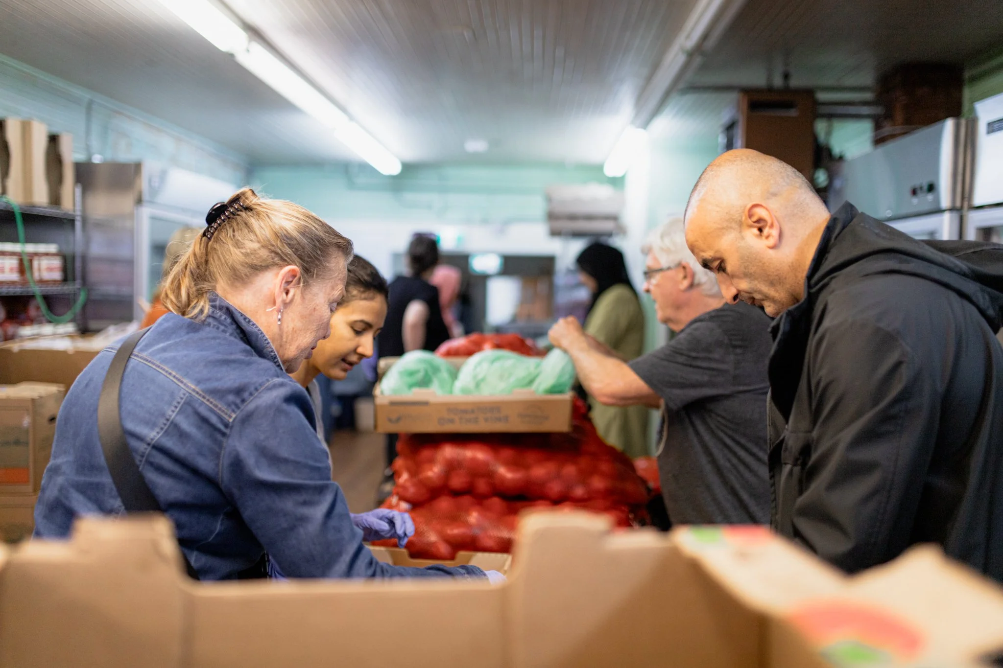 Volunteers sorting donated groceries at Raphael House in Langley BC