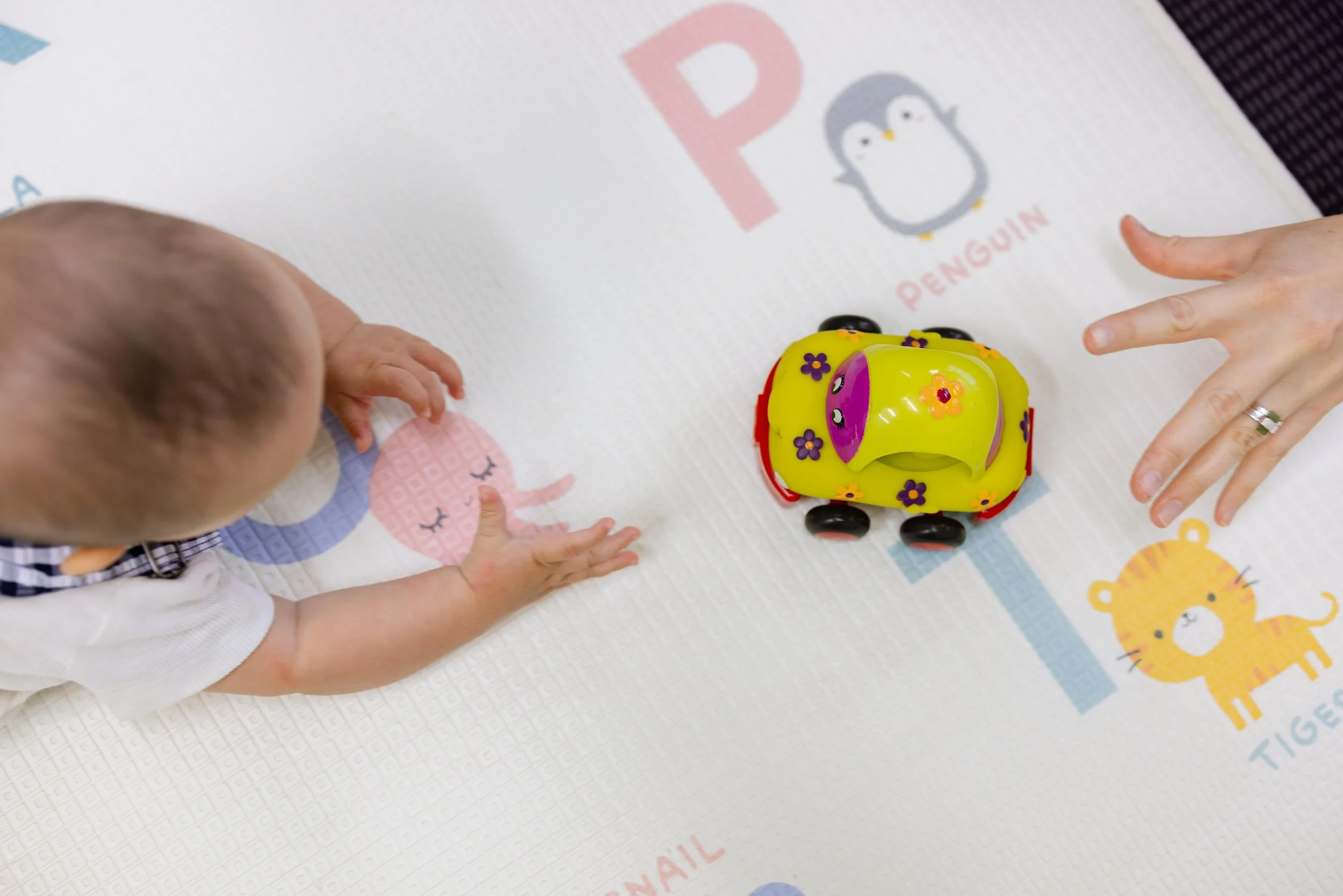 Baby crawling towards a toy