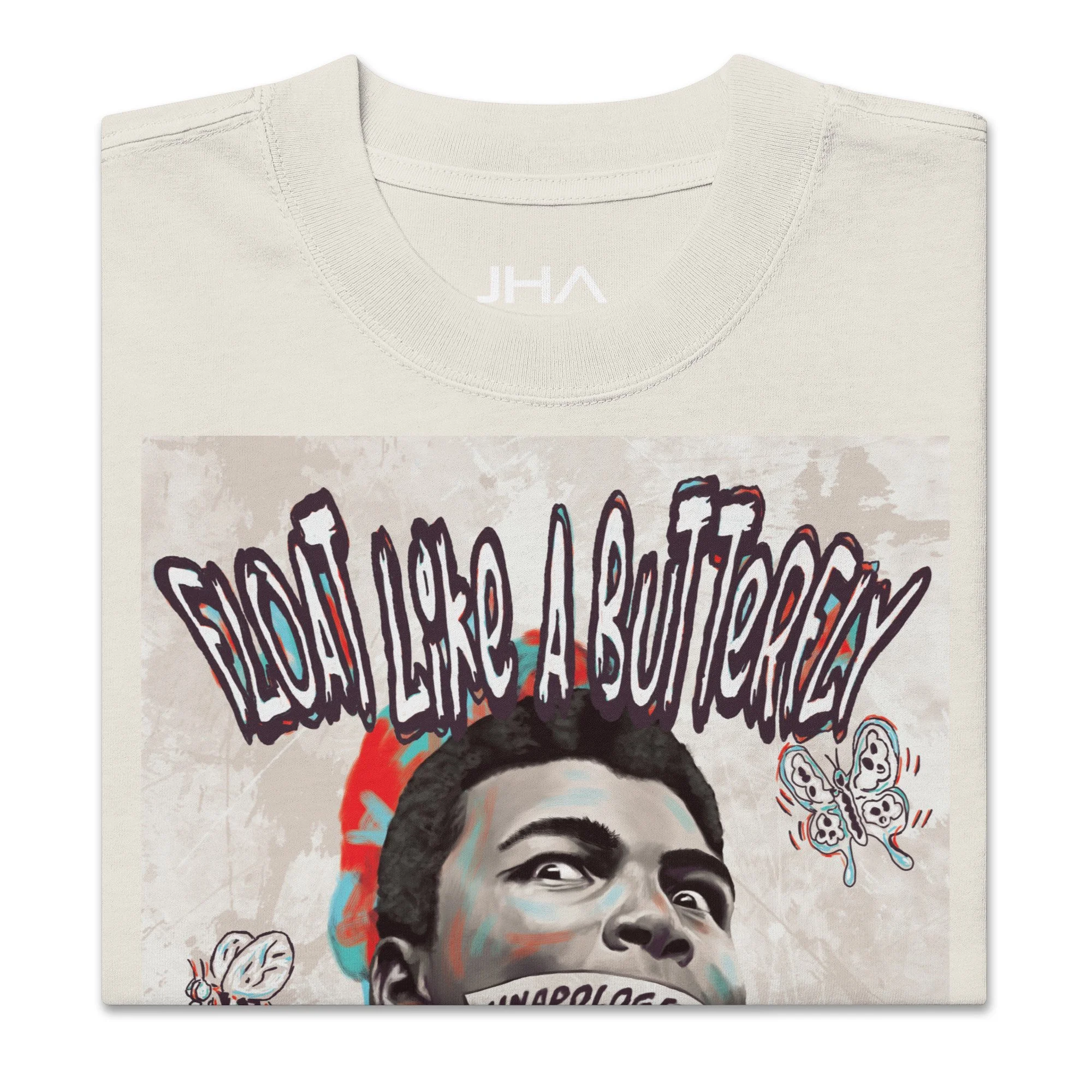 Folded oversized faded bone T-shirt with a Muhammad Ali graphic, featuring 'Float like a butterfly' text and symbolic imagery