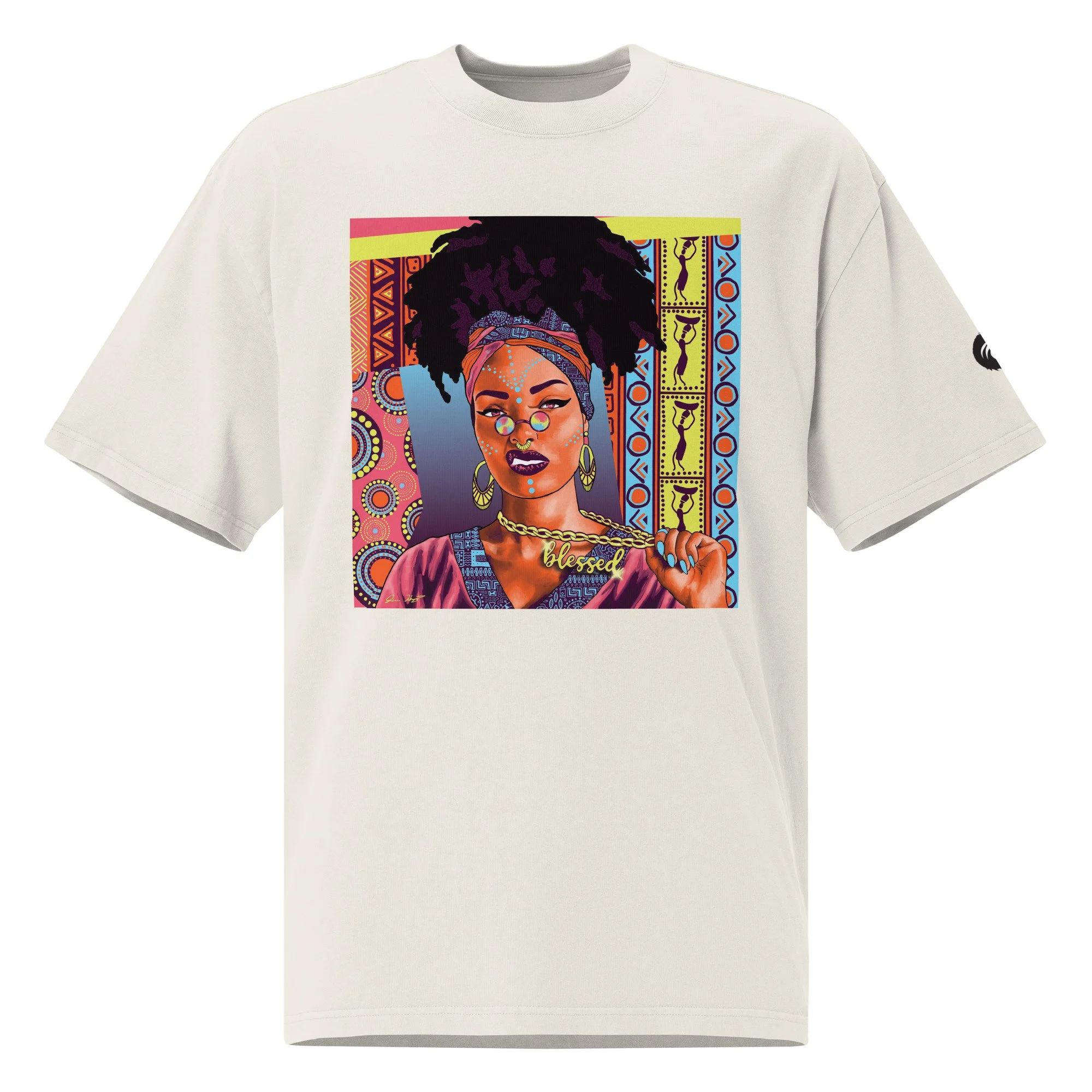Cream tee featuring a vibrant portrait of a Black woman in a patterned headwrap with blue face paint holding a gold “blessed” chain on a geometric backdrop.