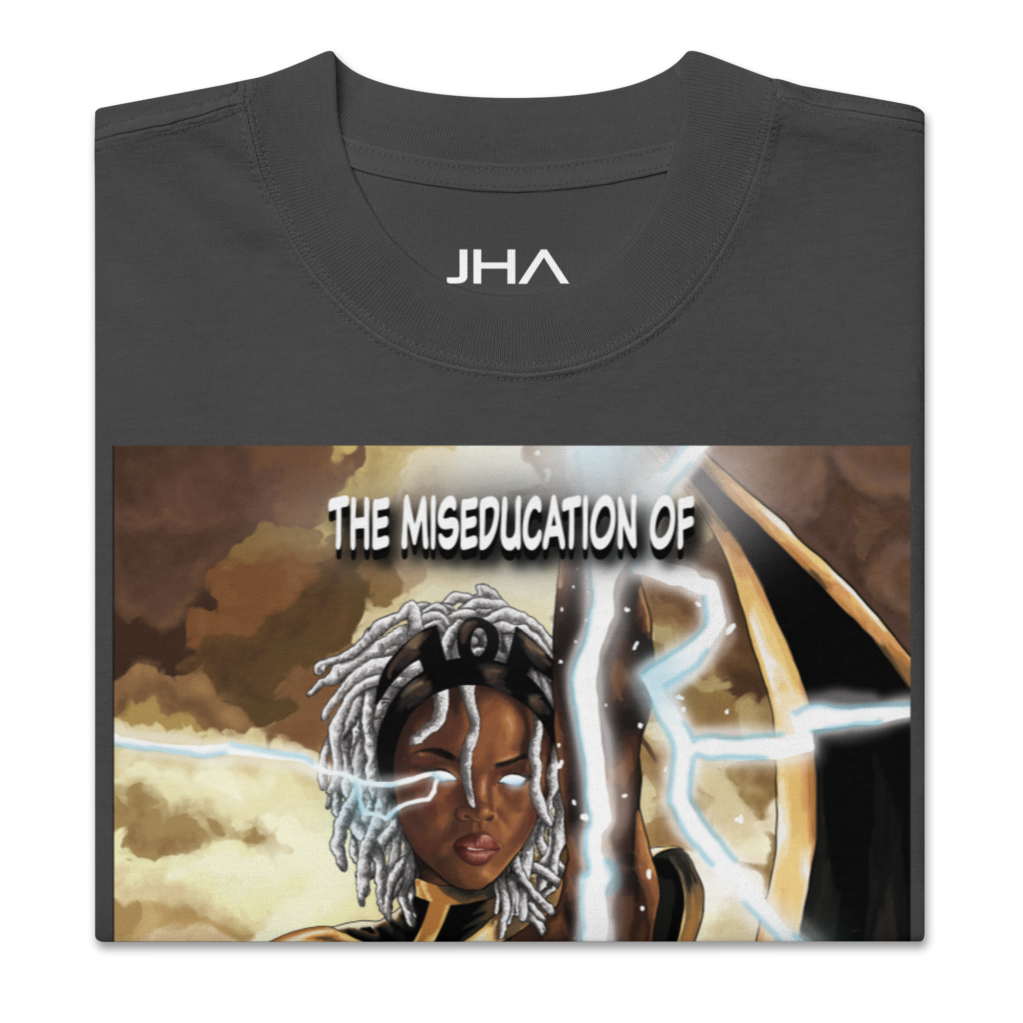 Folded oversized faded black T-shirt featuring 'The Miseducation of Storm' graphic, showcasing Storm with glowing eyes and lightning details.