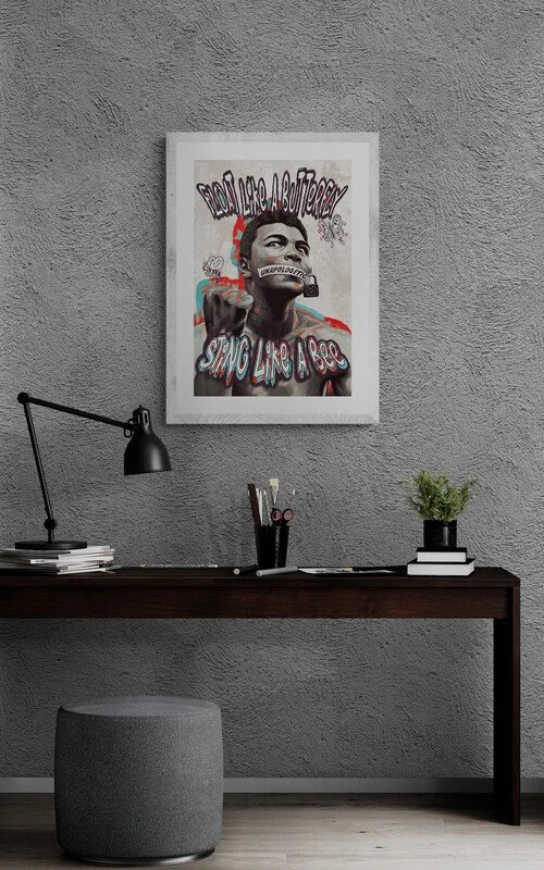 medium Muhammad Ali-inspired artwork with 'Float like a butterfly, sting like a bee' text displayed in a modern office