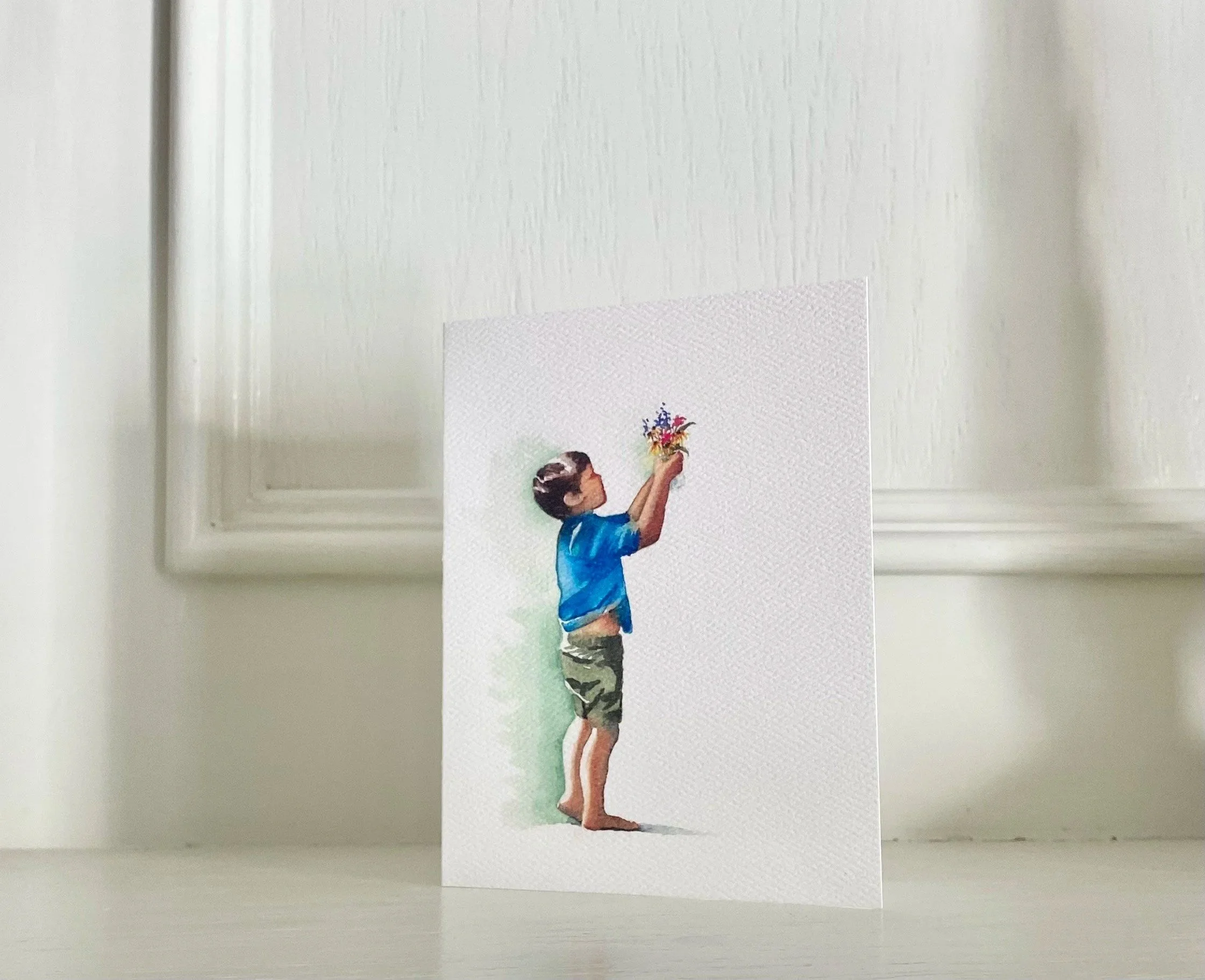 watercolor print greeting card of little boy holding up flowers