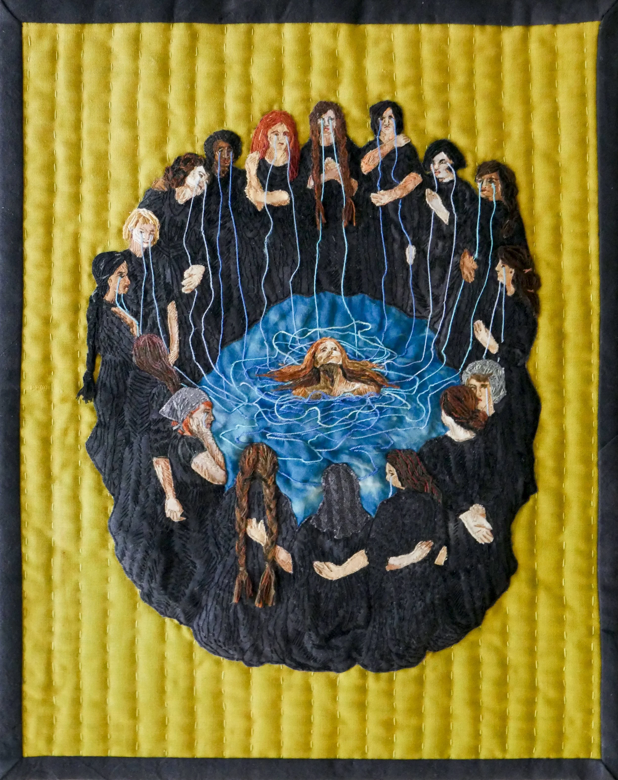 a yellow green quilted panel embroidered with a circle of people dressed in black with tears streaming down their faces into a pool of blue water where a face floats at the surface