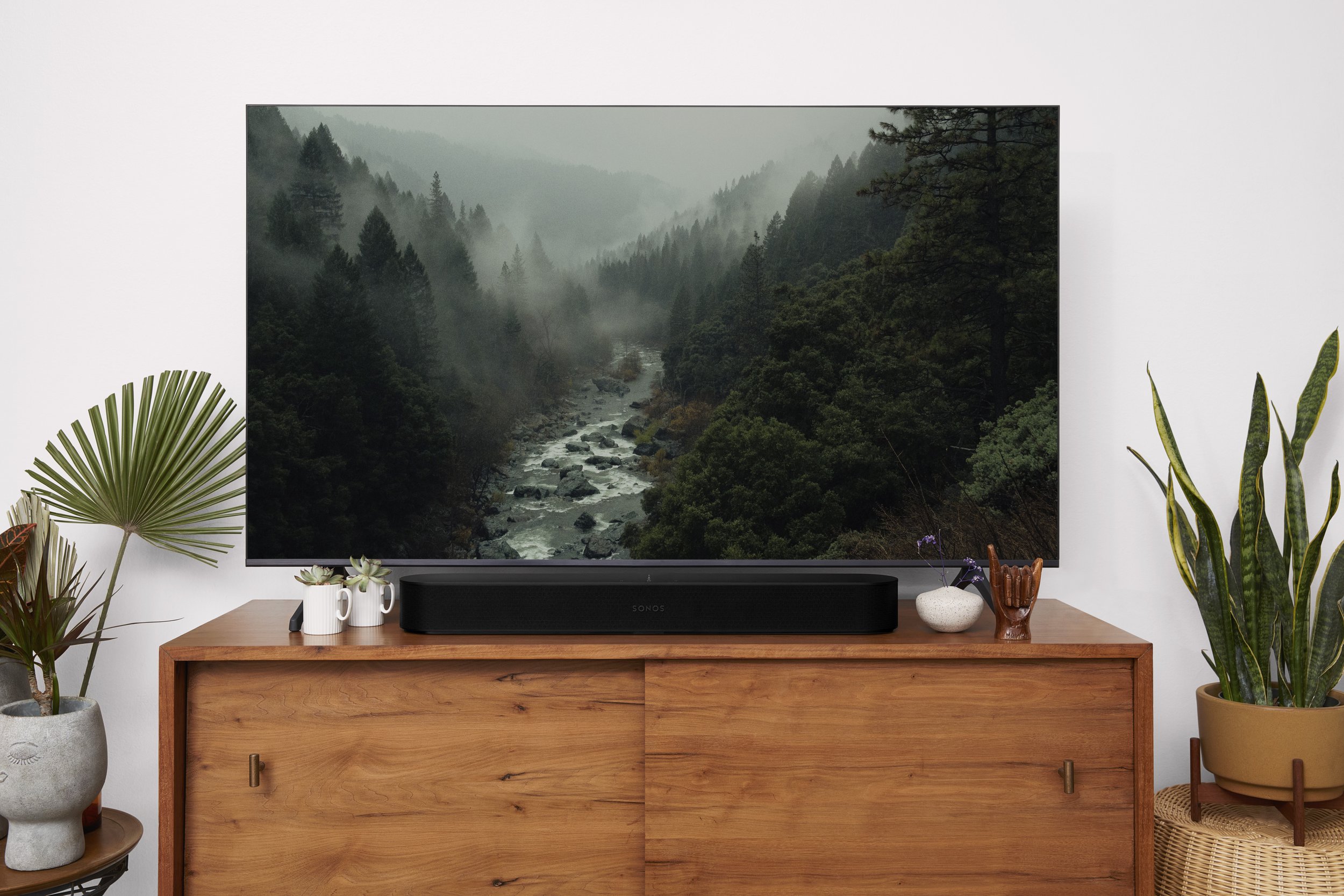A sleek black Sonos Beam soundbar sitting beneath a flat-screen TV in a modern living room. As an Authorized Sonos Dealer, Katabatic Connections provides premium home audio and custom home theater installations in Livingston and Bozeman.