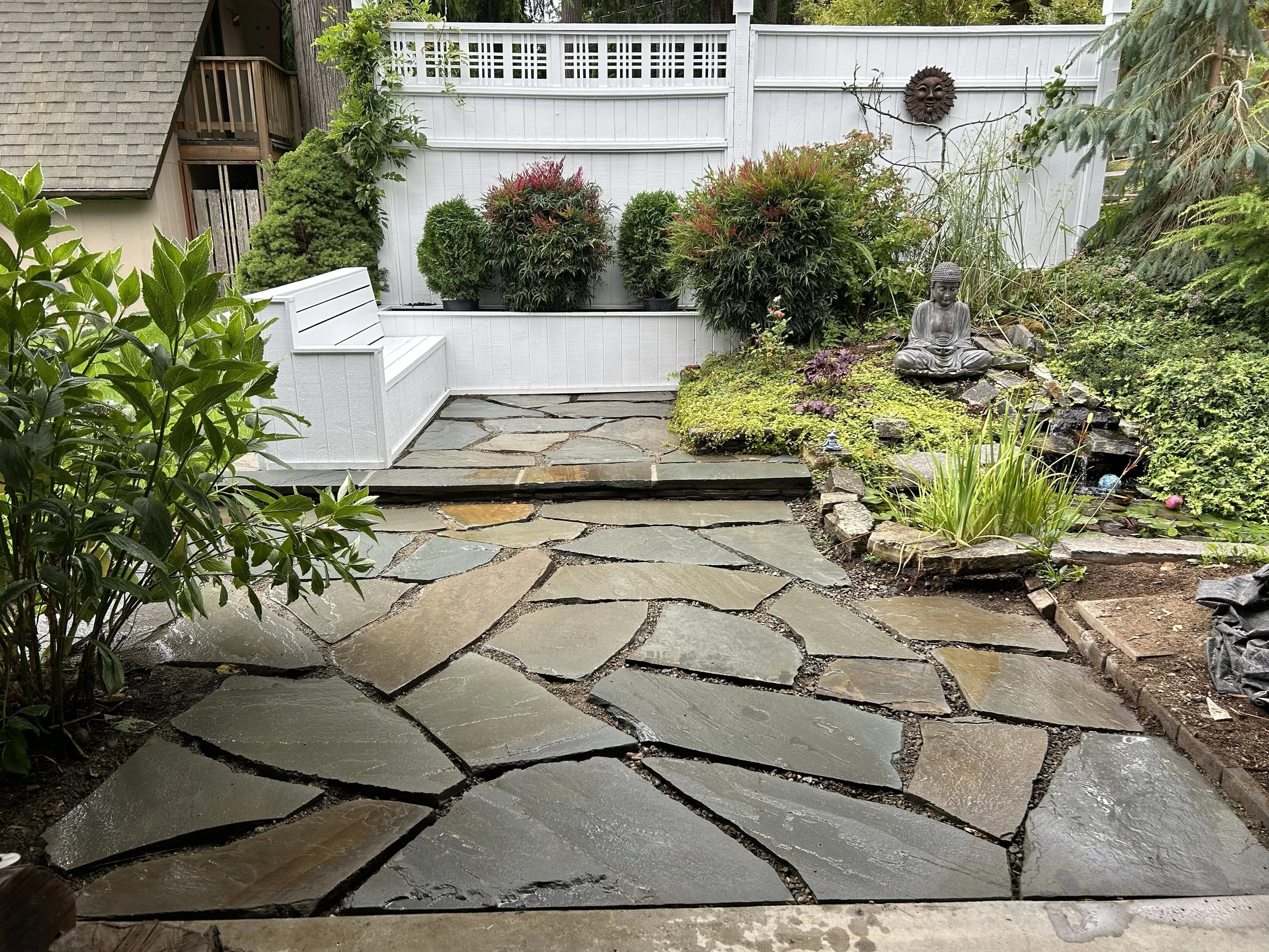 Beautiful stone patio with stone step and plants crafted by 7 Lamps Construction (Gig Harbor). www.7lamps.com