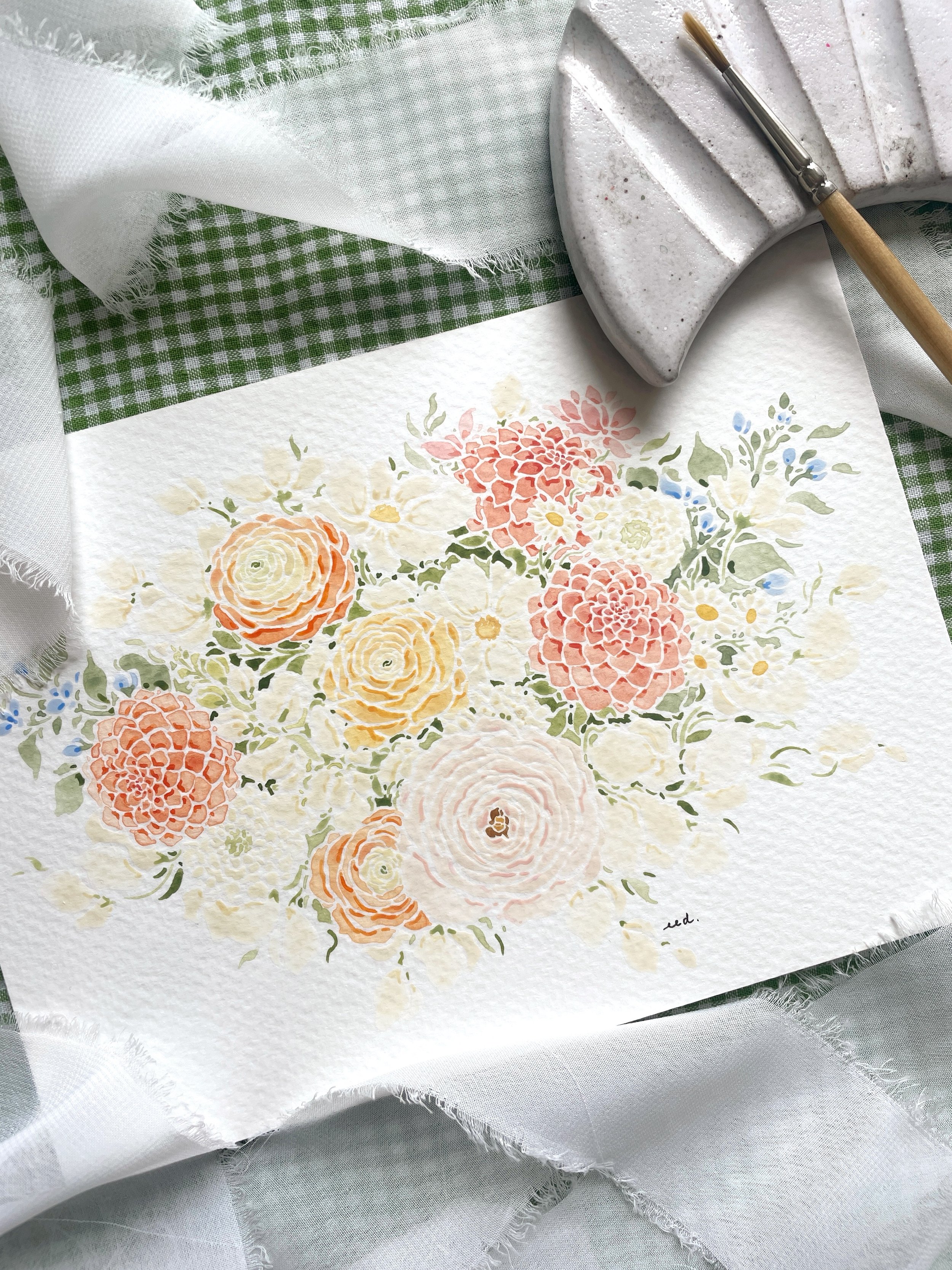 A watercolor painting of a floral arrangement featuring roses, dahlias, daisies, and other flowers in soft pastel colors on textured paper, surrounded by a paintbrush and artist's palette, with a green and white checkered cloth and a white fabric in 