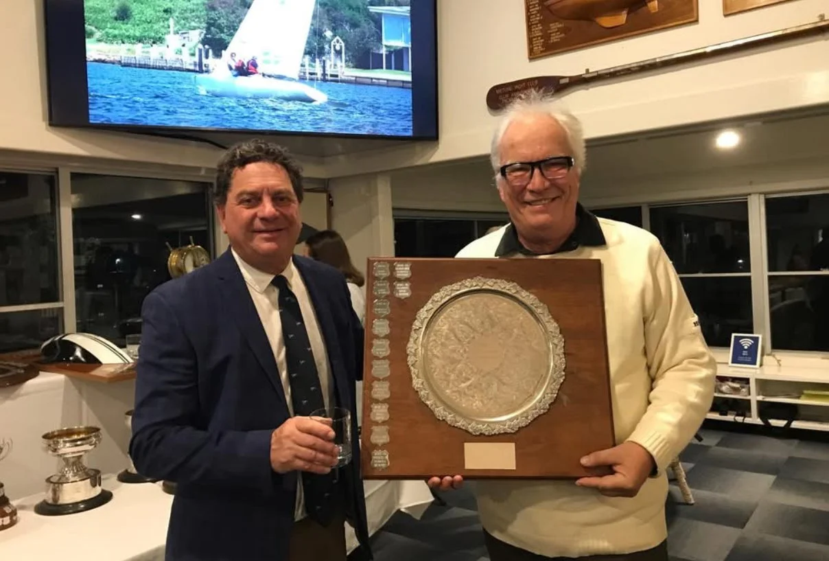 Commodore Peter Kanat with Stephen Renfree holding the Betty Dack Trophy, at Metung Yacht Club’s senior fleet trophy presentation dinner on Saturday. 
Renfree was representing his partner, Lee Renfree, who won the race helming Leading Edge in the 202