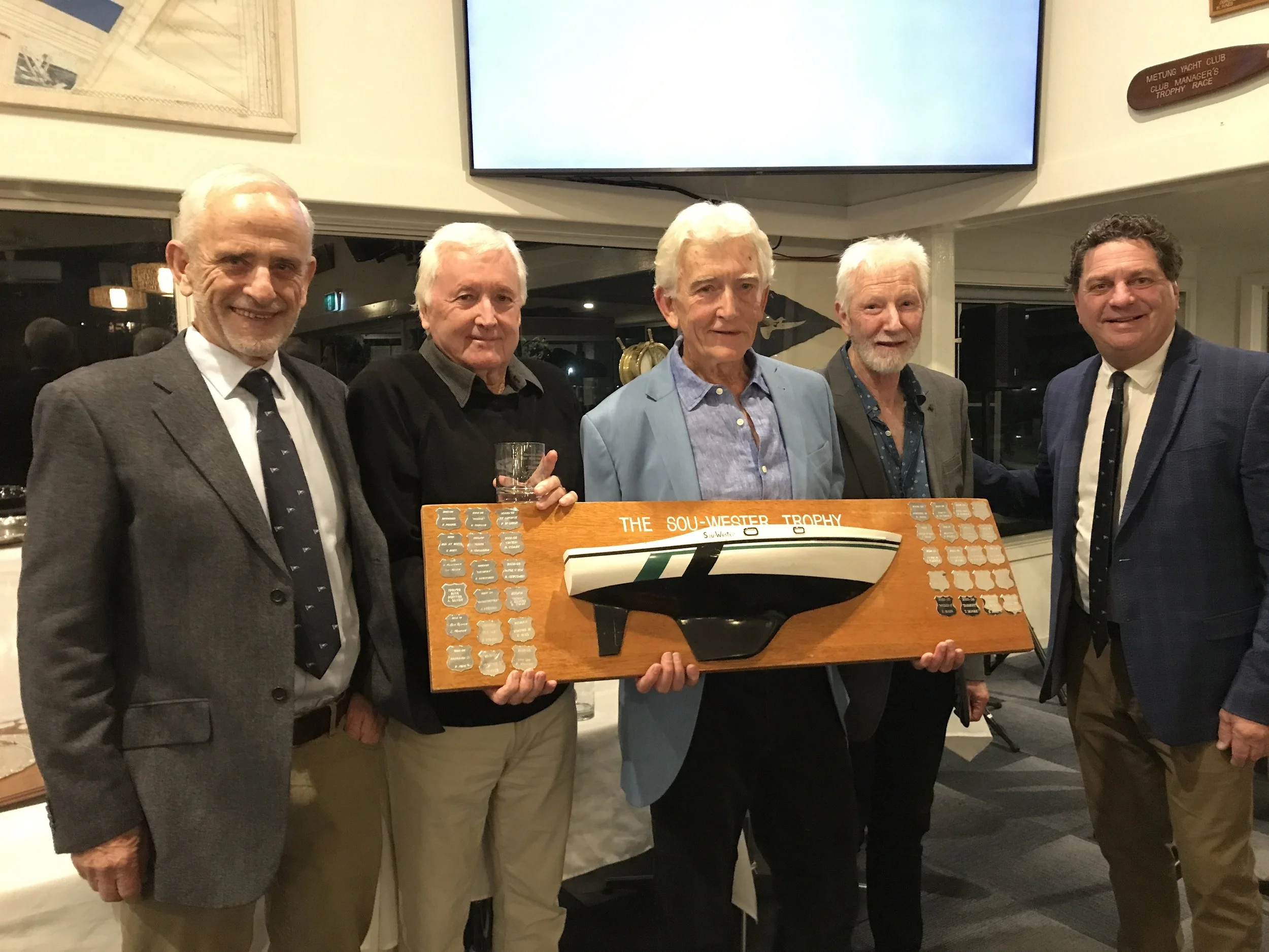 The crew of Harmony - Peter LeRoy, Bill Newcomen, Phillip Burn, Tom Moore (owner) and Rob Dimsey - received the Sou’Wester trophy on Saturday at Metung Yacht Club’s senior fleet trophy presentation dinner. They are pictured with Commodore Peter Kanat