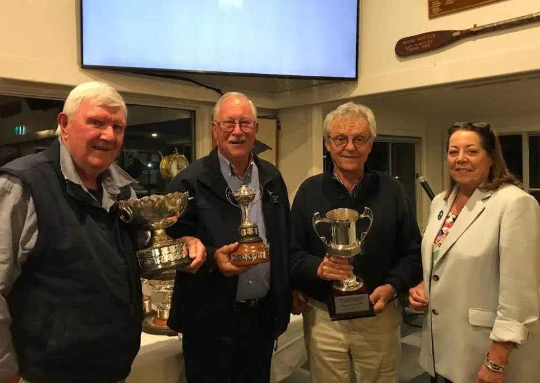 Les Tuckey (owner), Graeme Jamieson (helm) and Derek Russell with the trophies awarded to New Wave II - the Ray Dunn Memorial Trophy, Chichester Cup, and PB Lawrence Memorial Trophy - at Metung Yacht Club’s senior fleet trophy presentation dinner on 