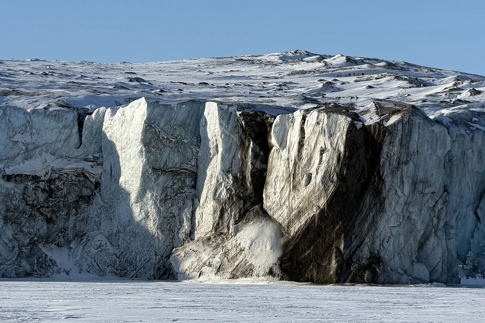 Standing on sea ice in front of a glacier