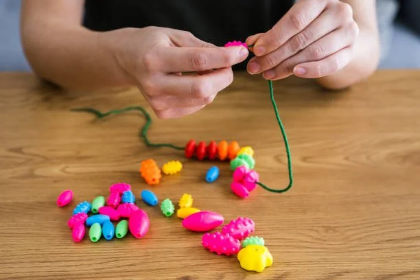 Occupational therapist guiding client through gross and fine motor skill development exercises