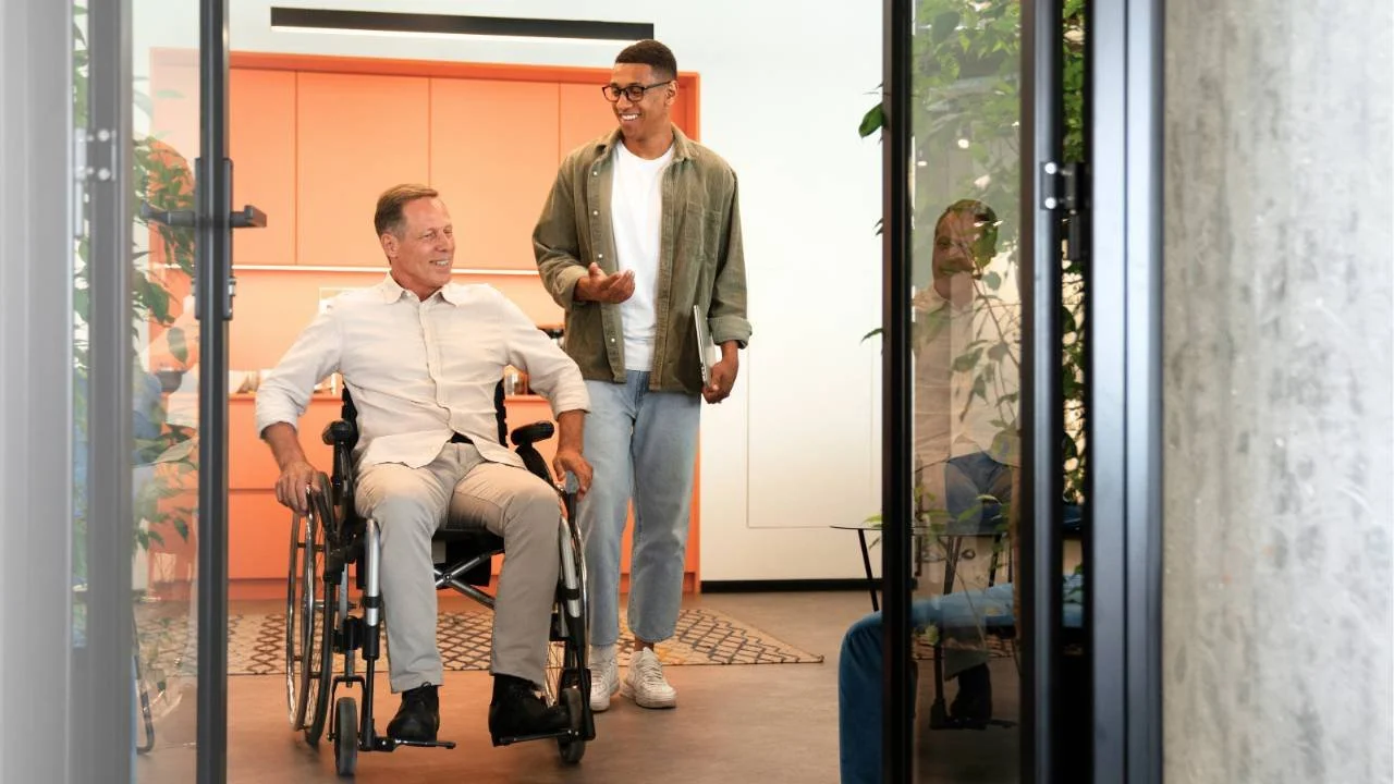 Occupational therapist assisting client with assistive technology trial and prescription