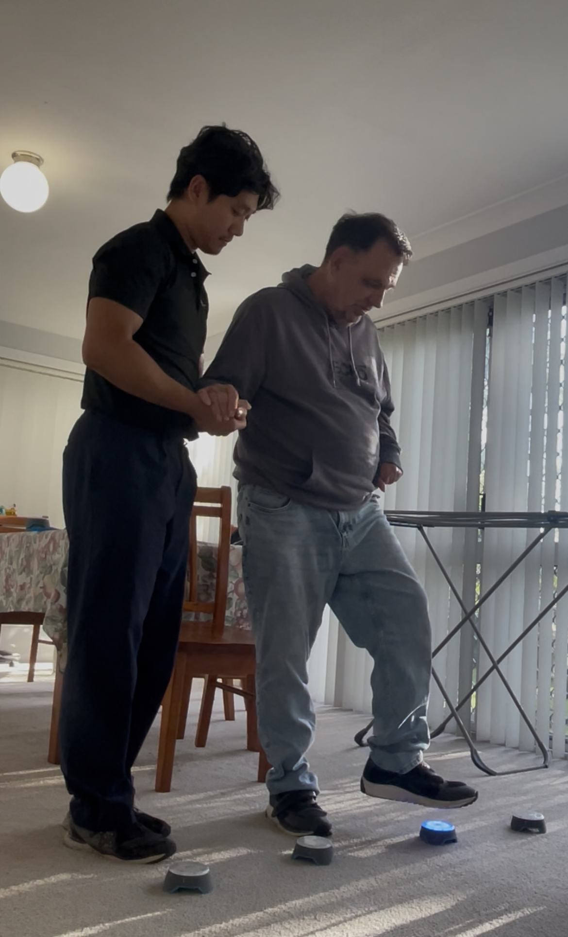 Physiotherapist supporting client with exercises for neurological rehabilitation