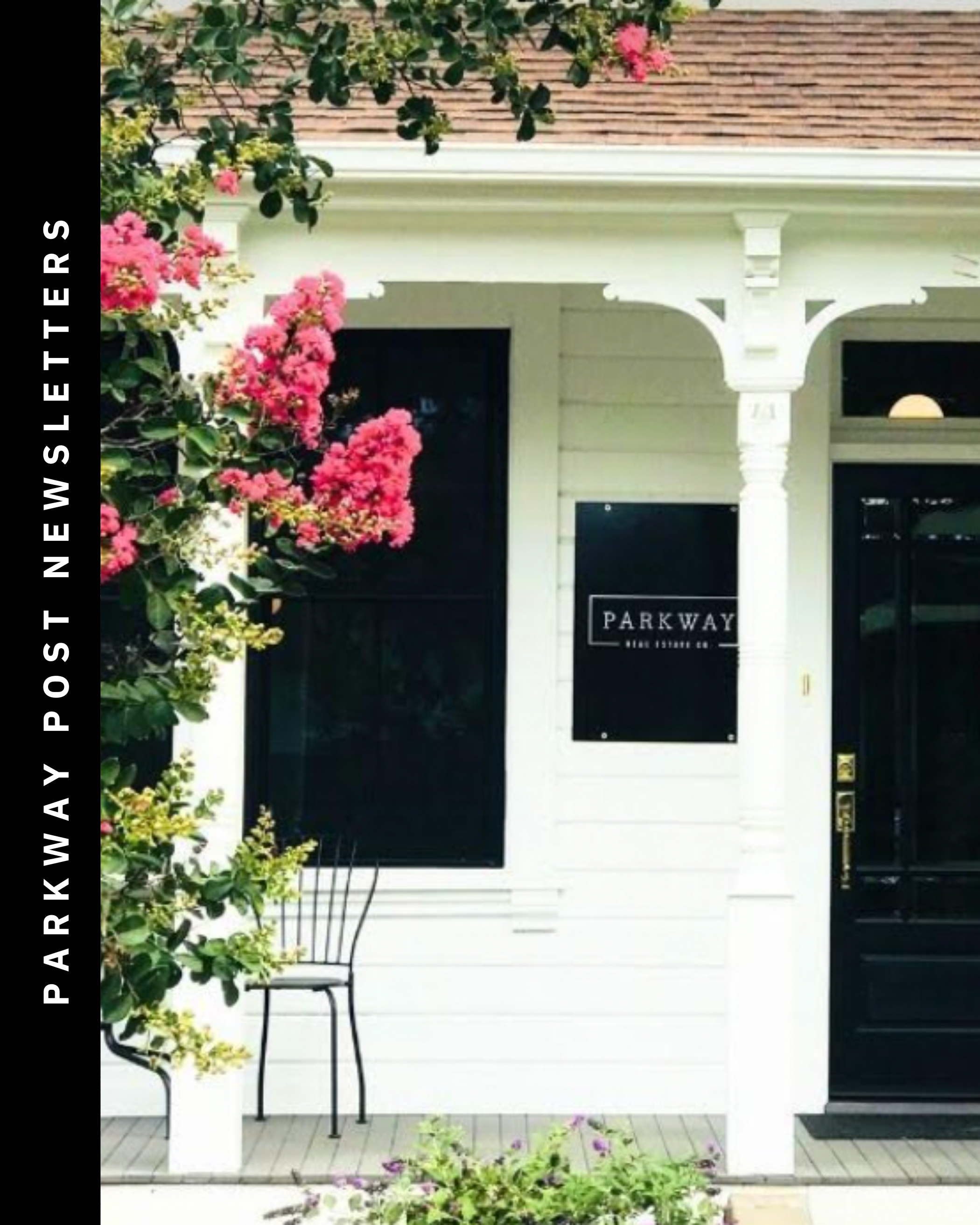 Front porch of a house with white walls, black windows and door, pink flowering bush on the left, a small black chair, and a sign that reads 'Parkway Real Estate Co.' in black and white.