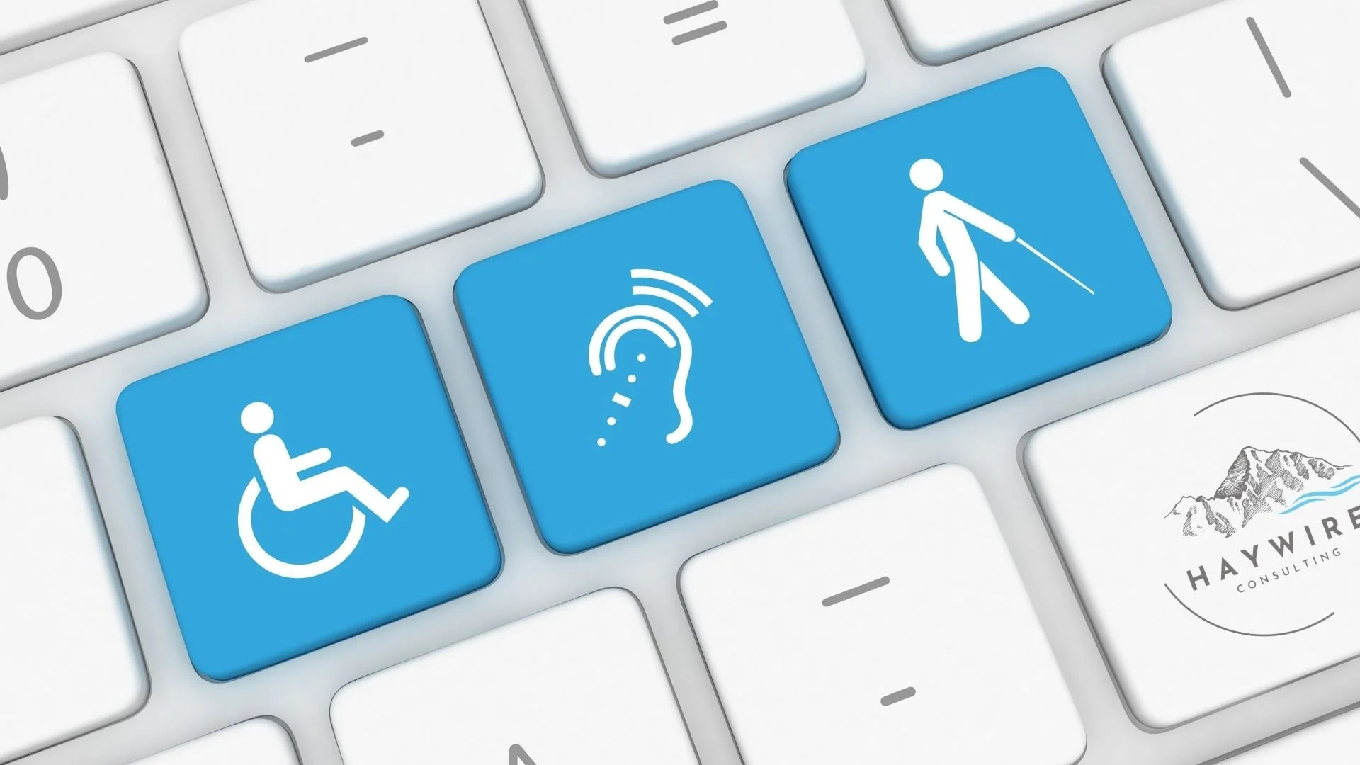 Close up of a computer keyboard featuring blue keys with universal accessibility and disability symbols next to the Haywire Consulting logo.