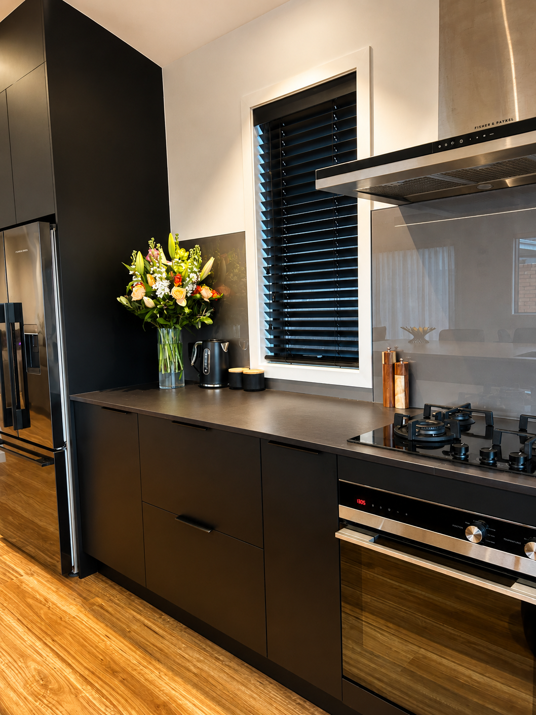Architectural kitchen detailing in the Riverhead new build by Parris Builds, featuring matte black cabinetry, integrated appliances and premium finishes.