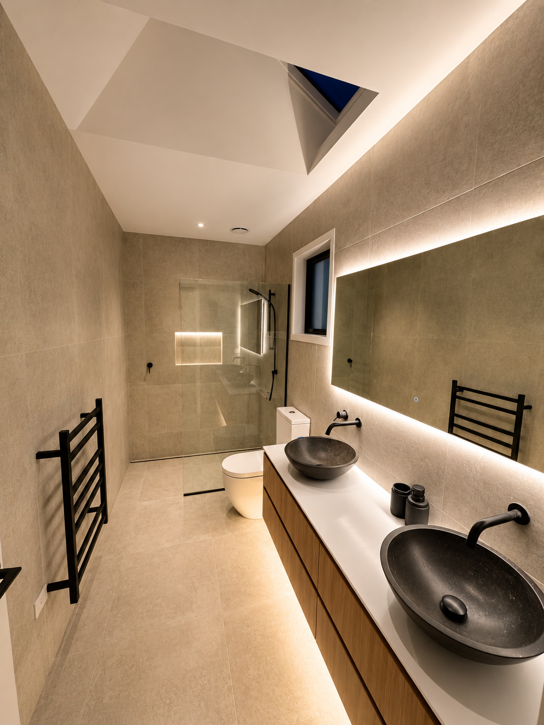 New Build Luxury ensuite by Parris Builds, featuring full-height tiling, timber cabinetry, skylight and premium fixtures.