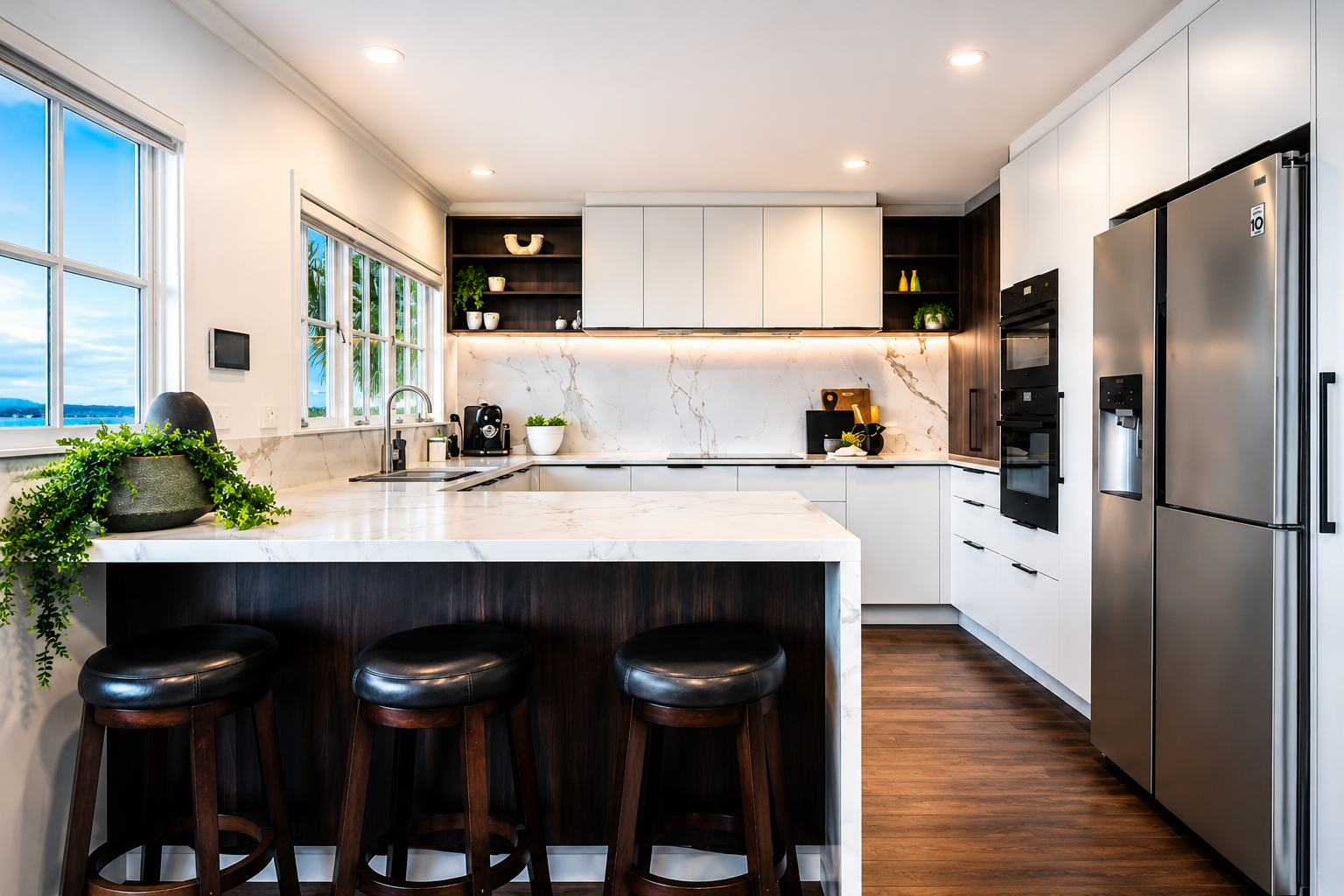 Modern kitchen renovation in Castor Bay completed by Parris Builds, featuring stone benchtops, custom cabinetry and a large island.