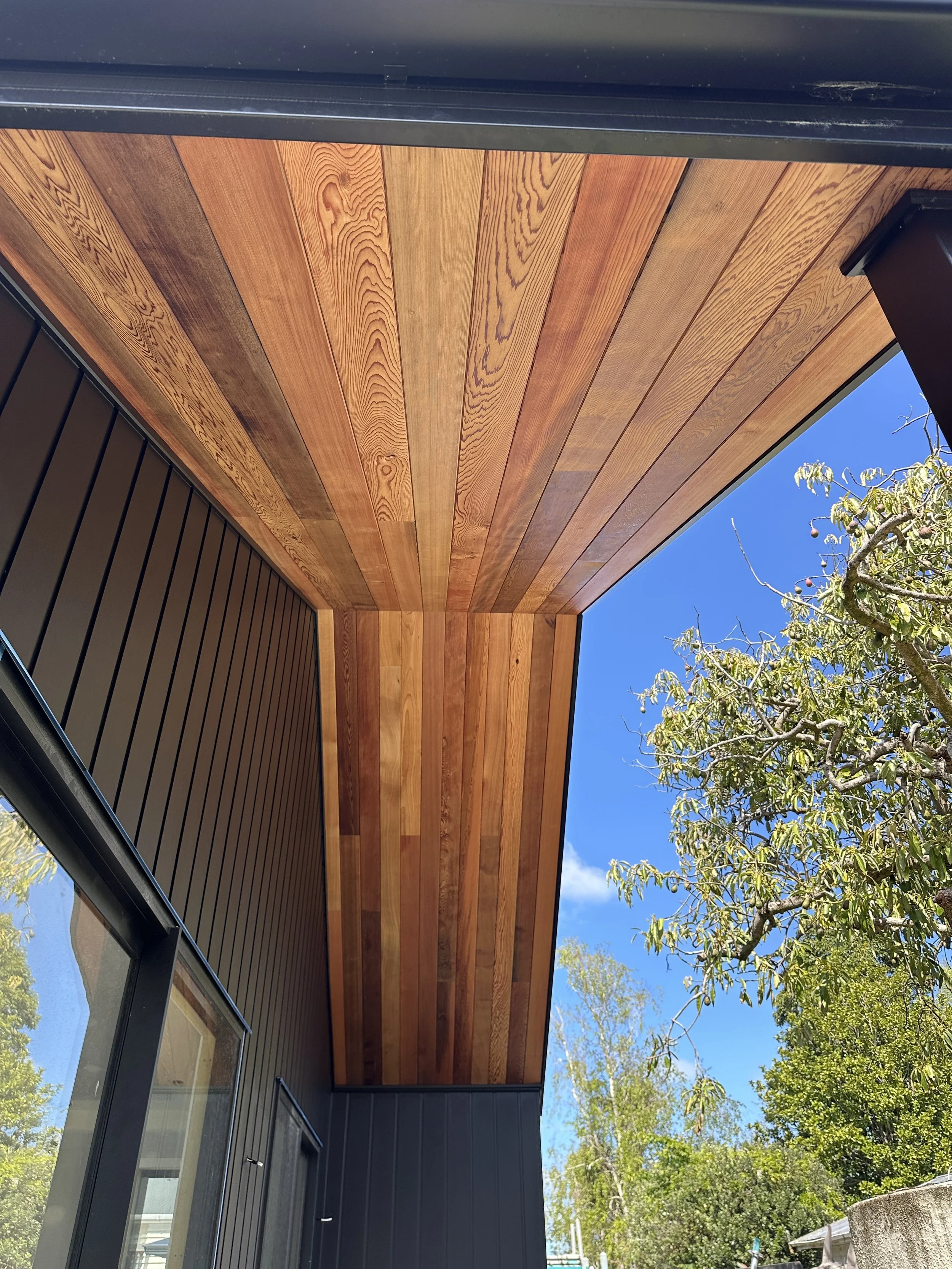 Architectural cedar soffit detailing and exterior accents completed by Parris Builds, showcasing premium craftsmanship and natural materials.