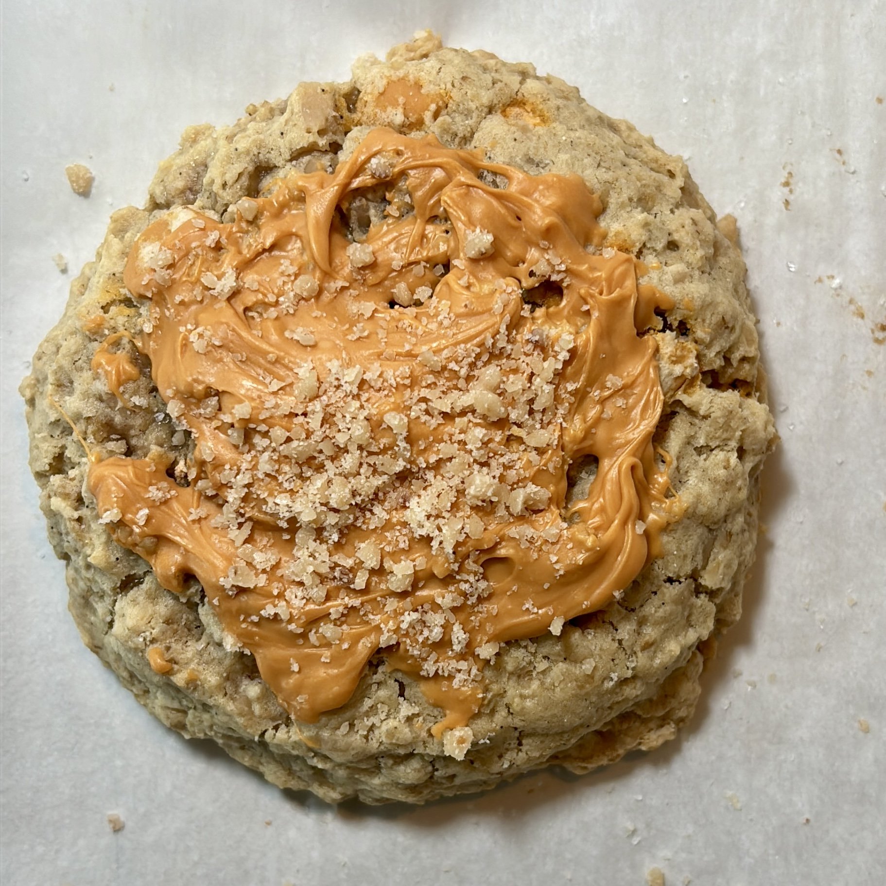 Oatmeal cookie with peanut butter and crushed cookies on top.