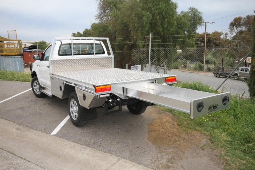 White pickup truck with a flatbed and extendable ramp. Ute tray Custom