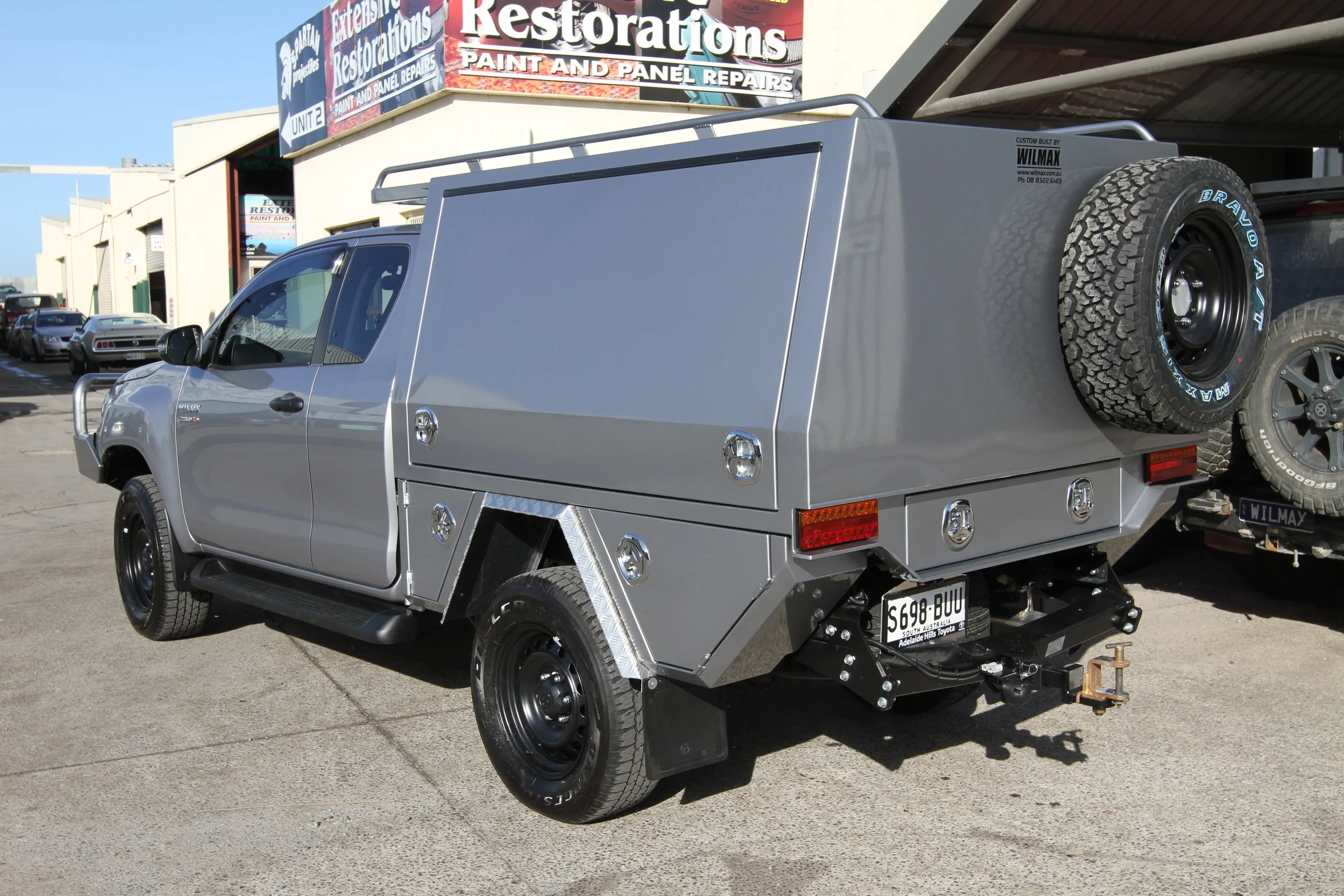 Silver utility vehicle with a large, custom canopy