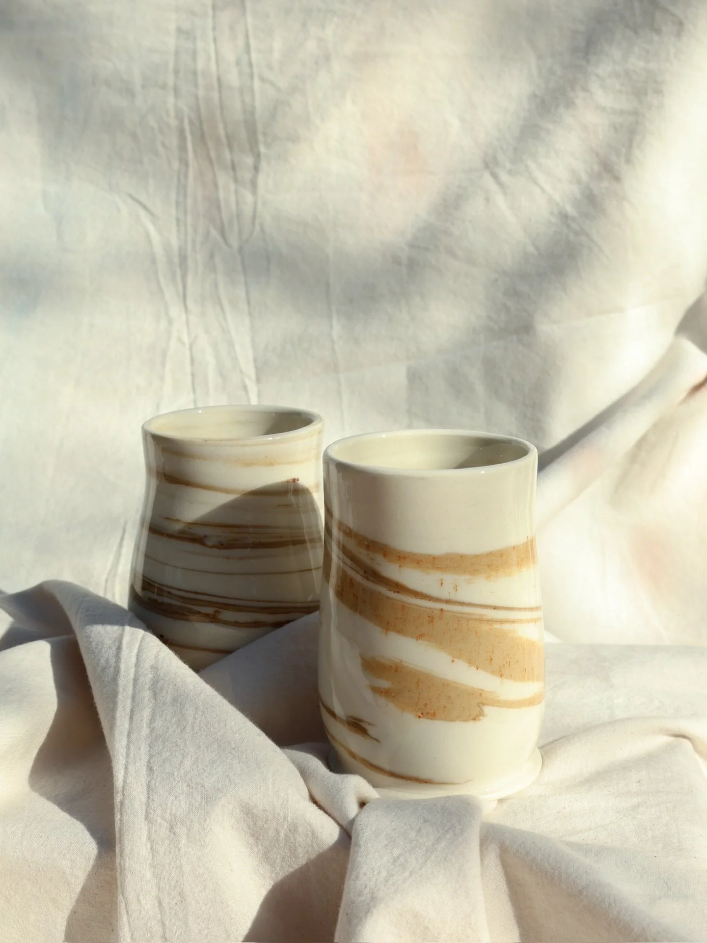 Sorry I haven't posted in a while! I'm away in Greece ...

The poetry of clay &bull; these porcelain tumblers feature a swirl of gold/brown stained porcelain. 

#porcelain #masonstain #ceramicartist #functionalpottery