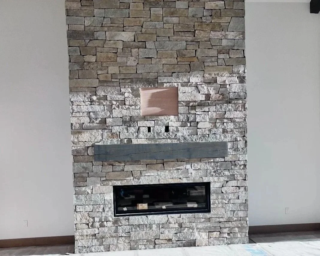 Decorative interior masonry wall with irregularly shaped stone pieces in varying natural tones.
