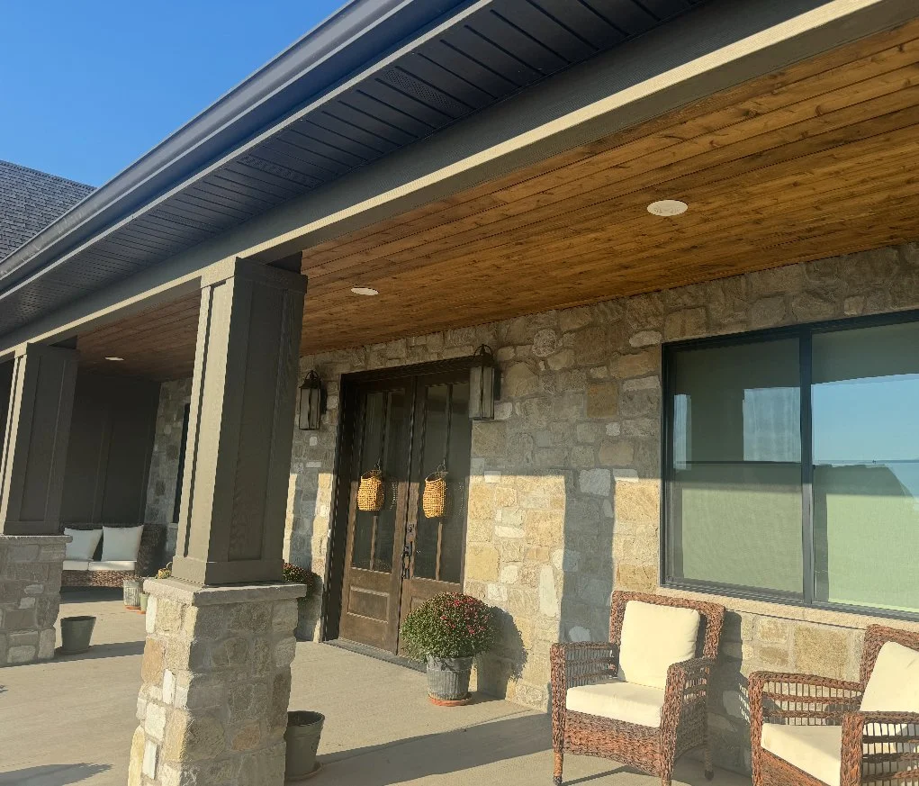 Custom porch columns with trim wraps, stone accents, and wood soffit