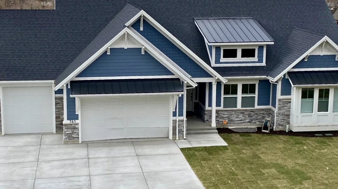 Blue painted home with white trims and gable accents