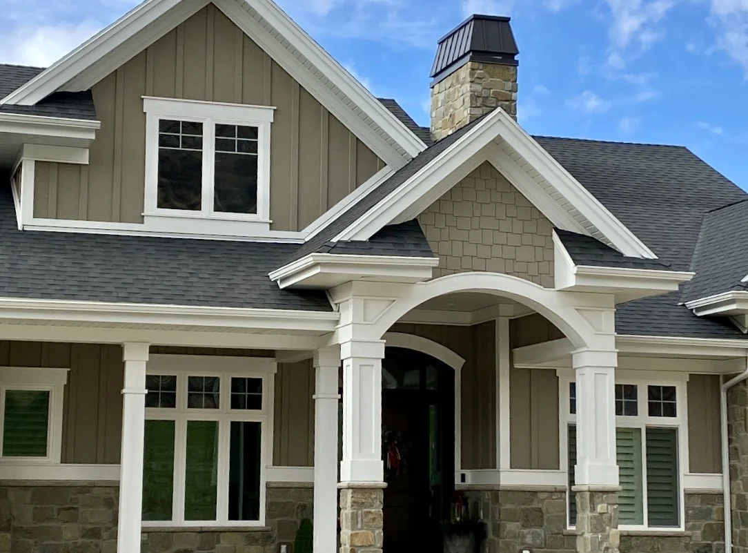 Detailed white trim columns and wrapped entry beams on a custom home