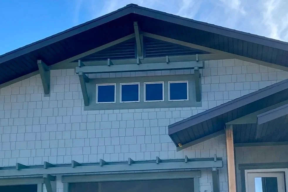Dark fascia and roofline trim on a two-story home with multiple gables.