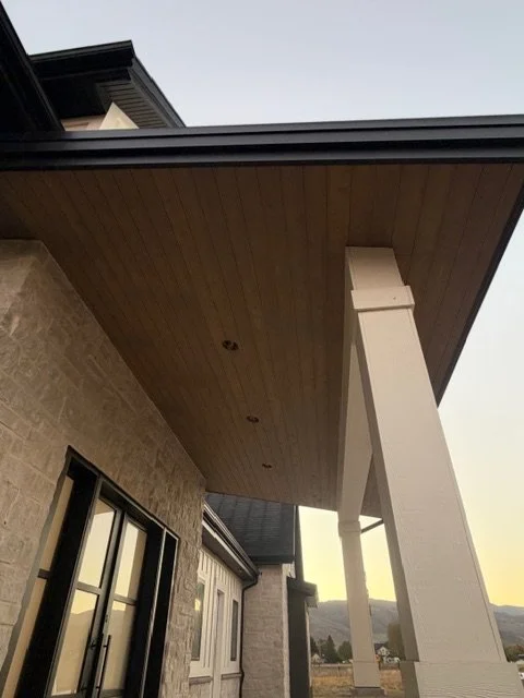 Tongue-and-groove cedar ceiling with a sloped design above a covered outdoor area
