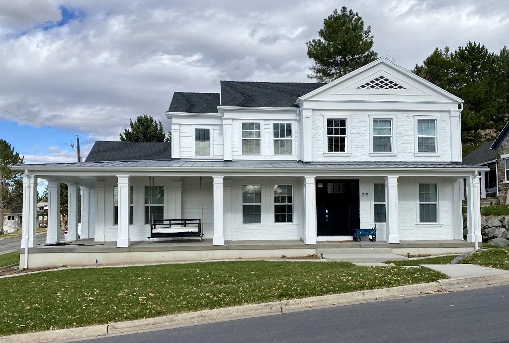 Custom white trim column wraps on the front porch of a residential home
