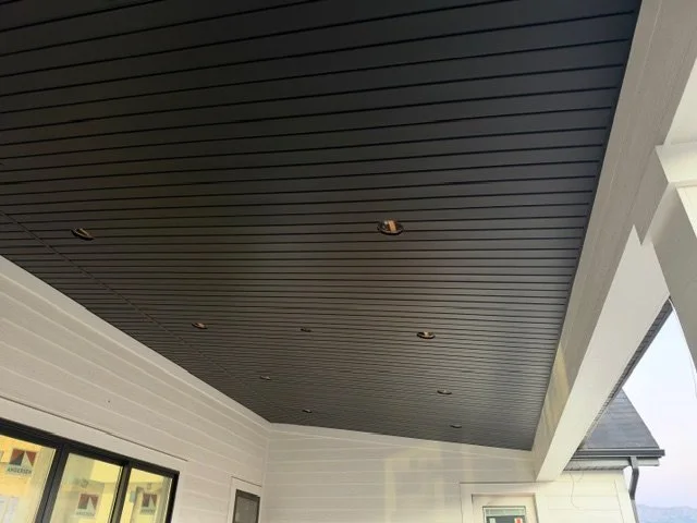 Dark aluminum soffit porch lid installed above a covered outdoor living space