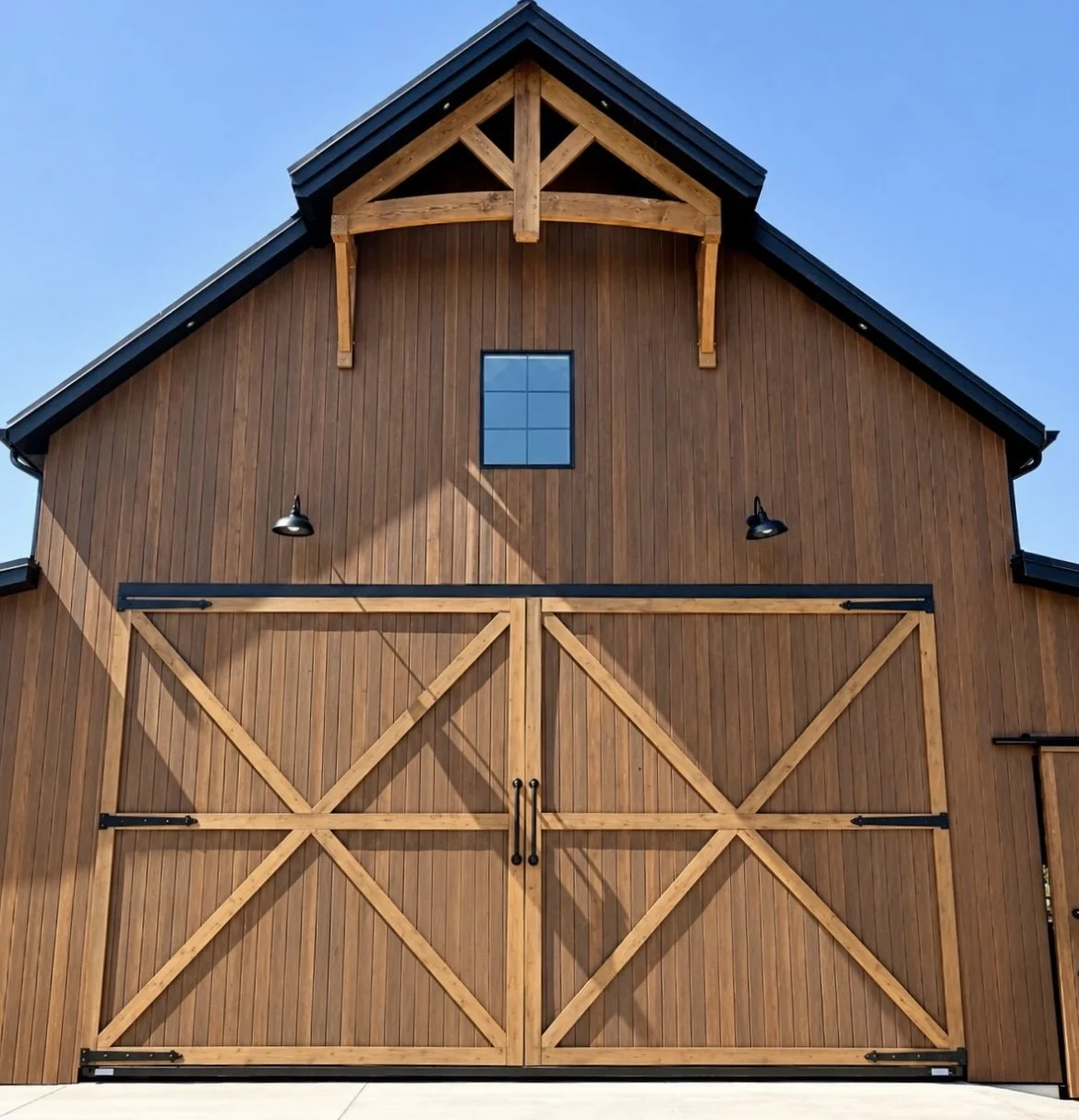 Wood-look vertical siding on a barn-style building with decorative timber gable accents and large cross-braced doors.