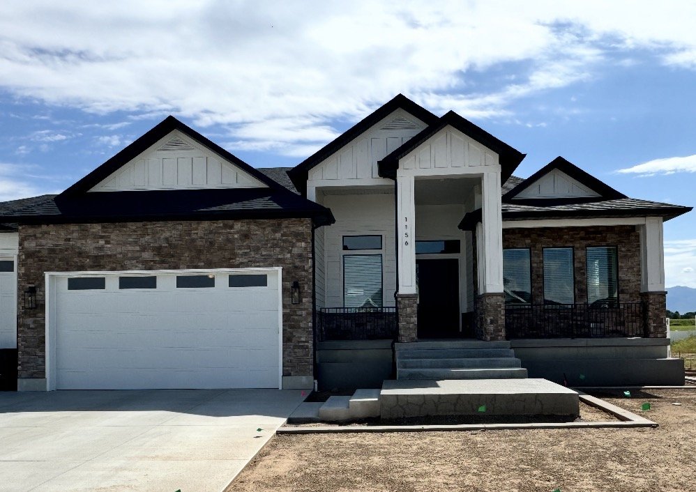 Manufactured stone veneer accents on a home's garage, front entry, and exterior walls