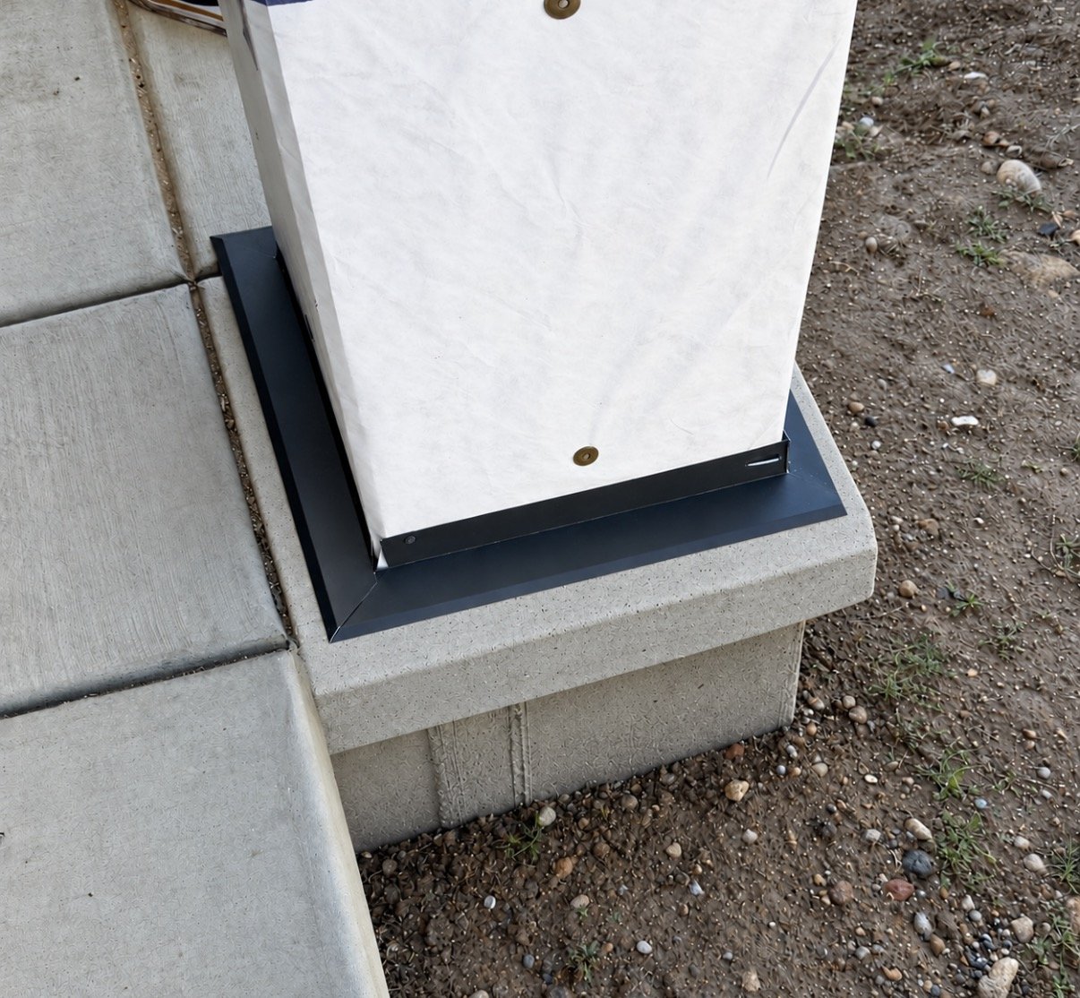 Custom metal flashing installed around the base of an exterior wall to provide a clean finish and help direct water away from the structure.