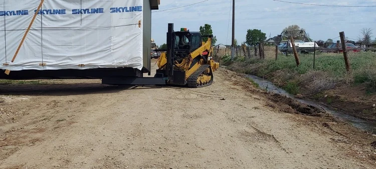 Equipment grading a site
